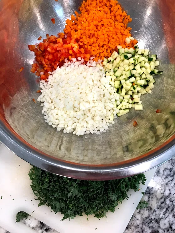 Here are all the veggies together with the frozen cauliflower rice. No need to thaw, you will cook it with the other veggies. I purposefully did not include the kale in this mix so it would not turn the entire nugget green. Kids are weird and the color green is like flashing "Danger Will Robinson!!!!" so its easier to explain a few little specs as everyone's favorite, RANCH!