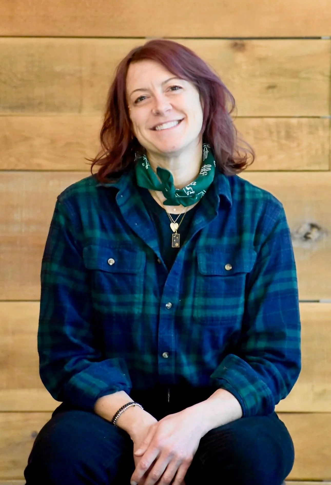 Sara Munson, CPDT-KA, Director of Behavior & Trainer Development at Far Fetched Acres, smiling in a professional portrait.