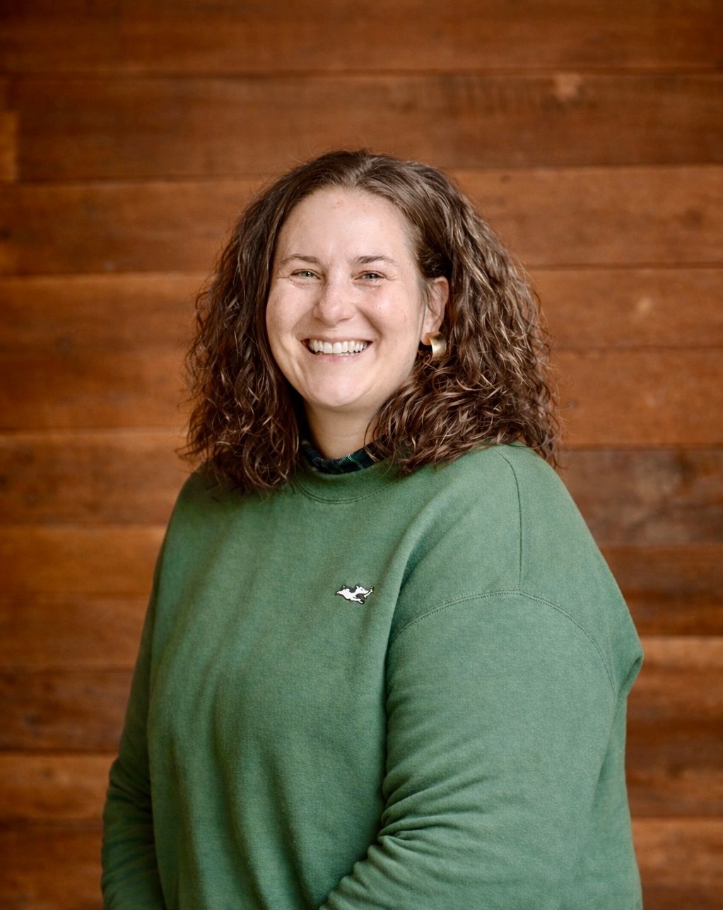 Kara Russell, Client Services Lead at Far Fetched Acres, smiling in a professional portrait.