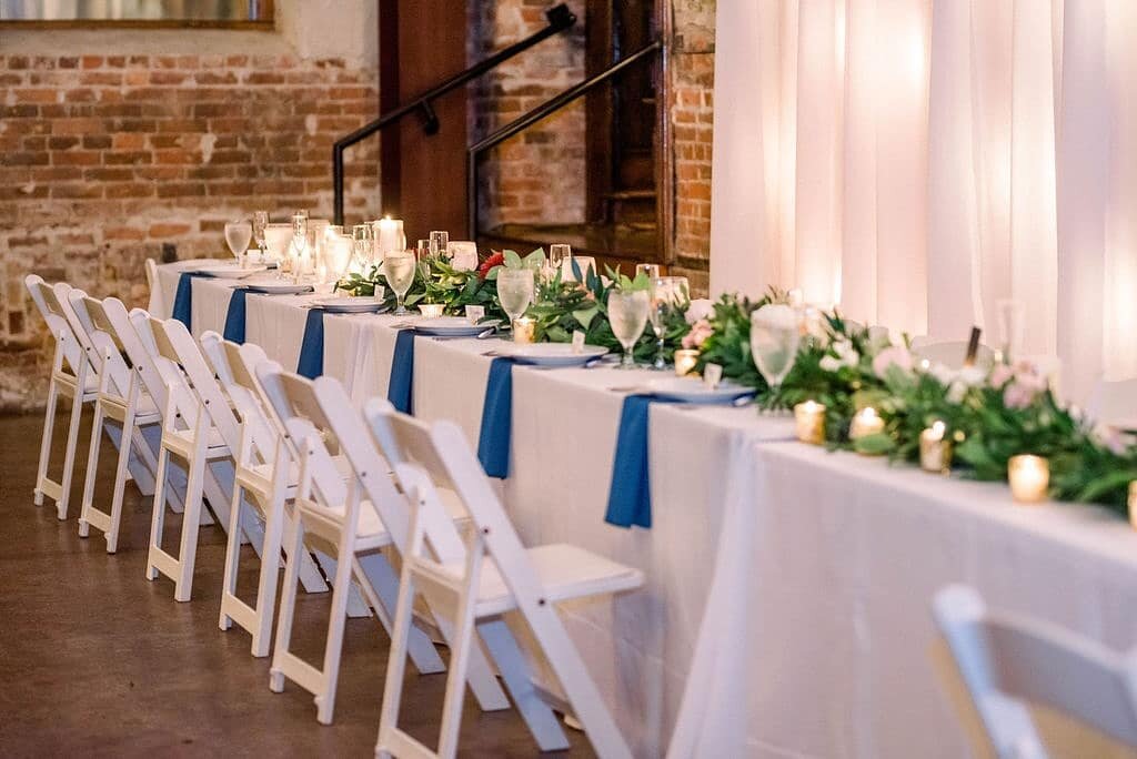 classic white on white with drapes will always make a space feel clean and elegant. dress it up with a lush garland and candles for that perfect longggg head table. 
 . 
 . 
 . 
#wilmingtonweddings #wilmingtonweddingplanner #weddingplanner #headtable