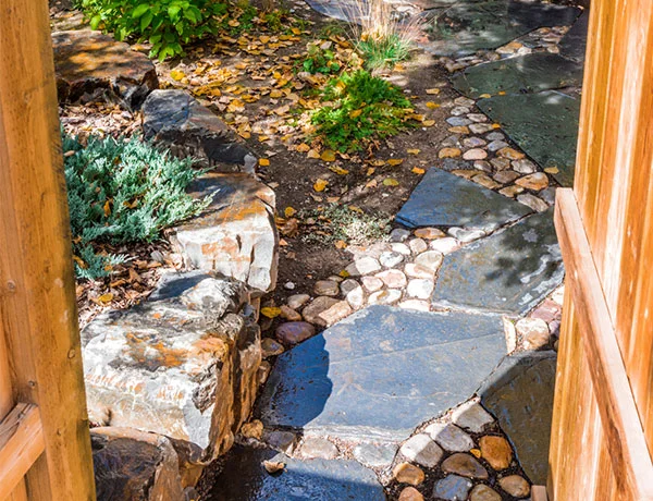 A backyard featuring a stone walkway in the Calgary and Banff area