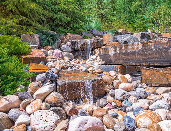 A custom stone waterfall feature in the Calgary and Banff area