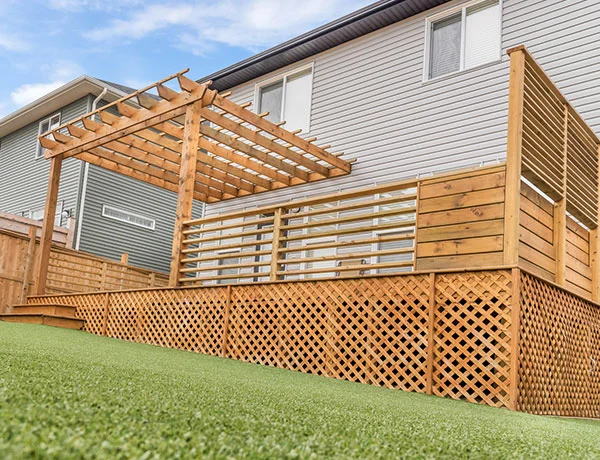 A wooden outdoor enclosure positioned against the side of a house in the Calgary and Banff area