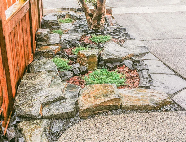 A yard featuring stonework inspired by the Rocky Mountain landscape in the Calgary and Banff area