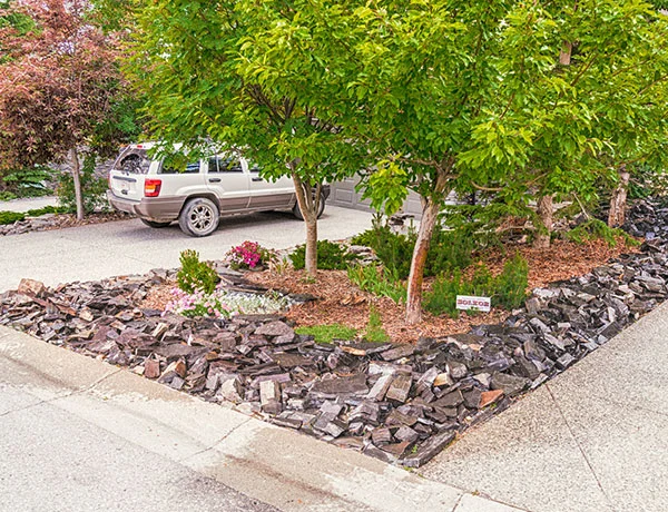 A front yard featuring custom outdoor lighting and stonework in the Calgary and Banff area