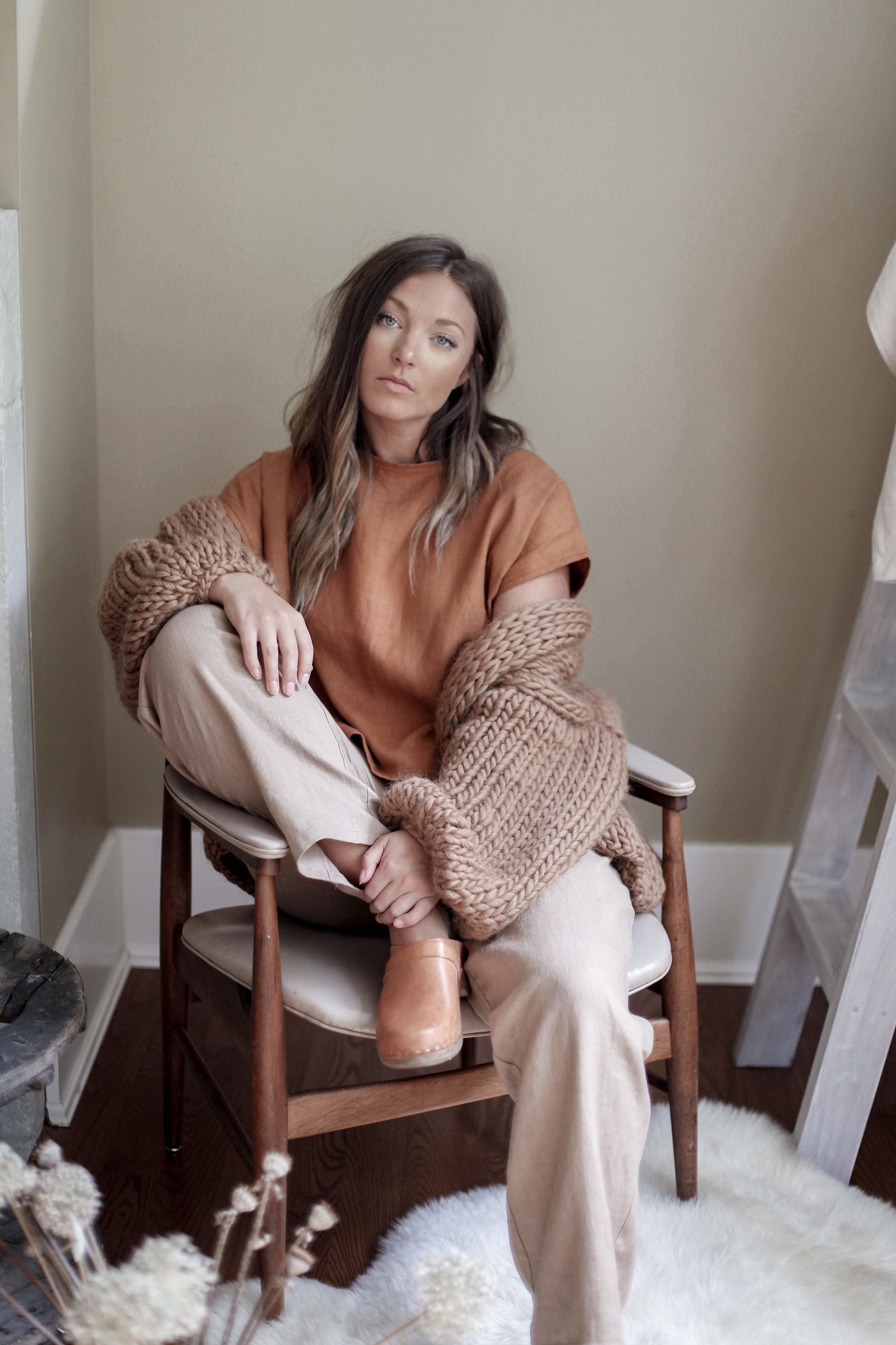 nomi-designs_jessie-top_rust-colored-natural-linen-short-sleeve-top_front_paired-with-lyndsey-pants_styled-with-hendrik-lou-sweater.jpg