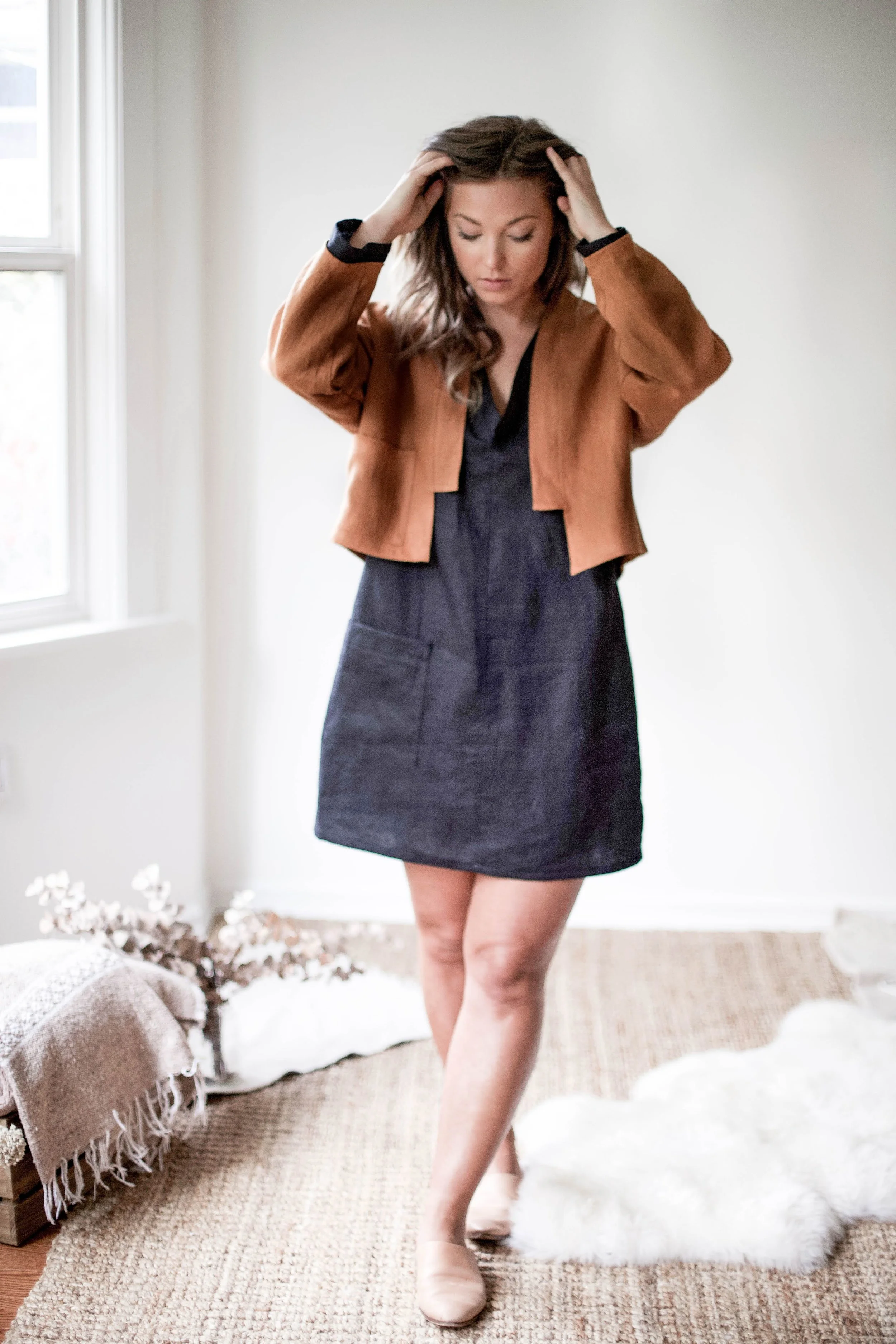 Handmade natural linen clothing by Nomi Designs in Victoria, BC | earth tone rust colored linen jacket with front pockets and angular front detail - front detail
