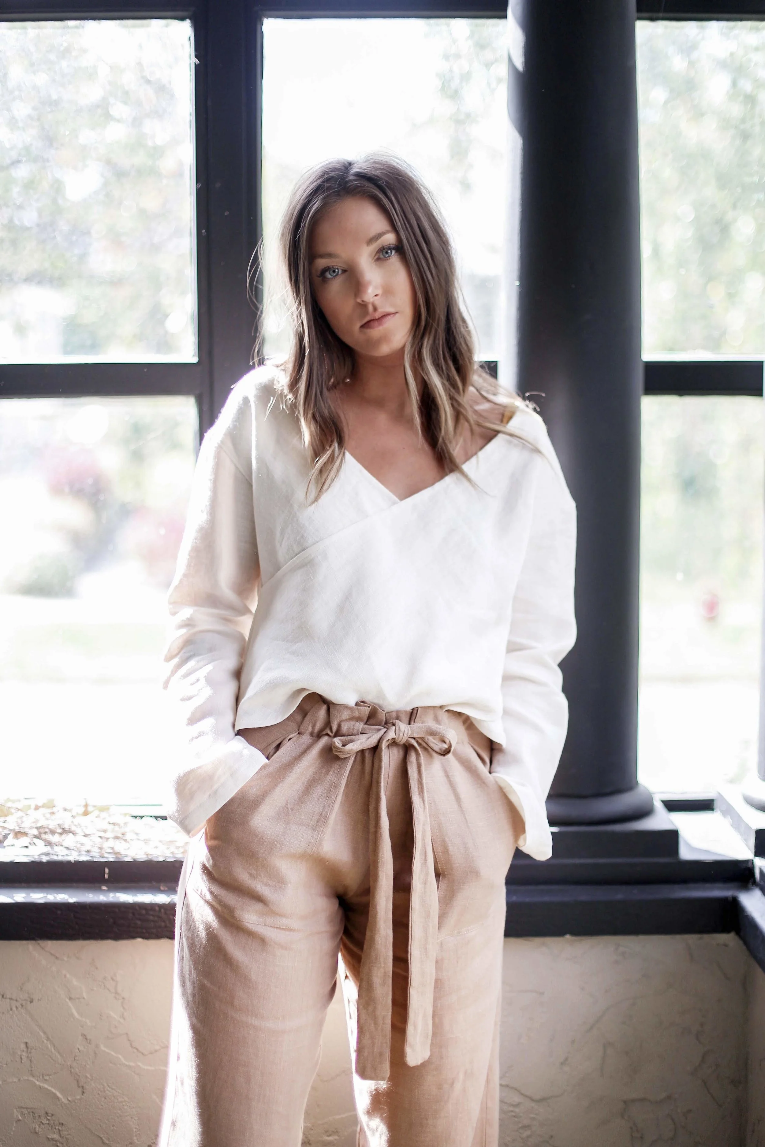 Handmade natural linen clothing by Nomi Designs in Victoria, BC | camel colored linen pants with pockets and tie waist paired with while linen v neck top