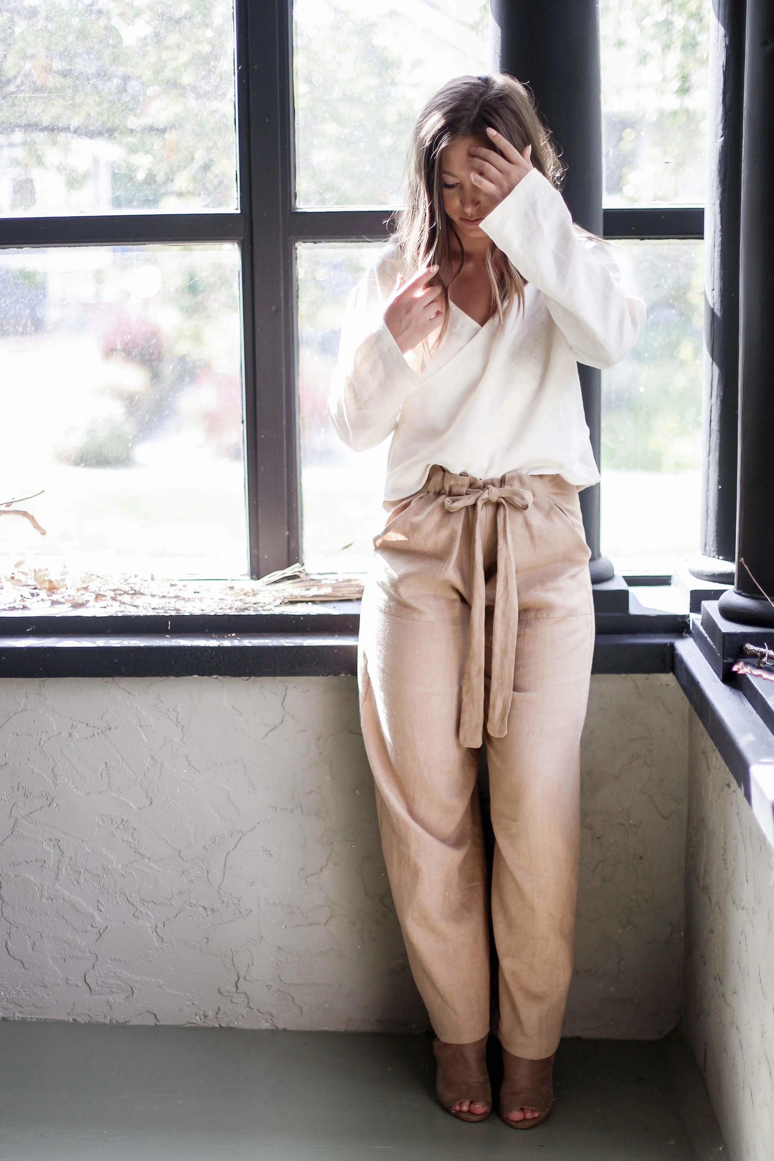 Handmade natural linen clothing by Nomi Designs in Victoria, BC | camel colored linen pants with pockets and tie waist paired with while linen v neck top