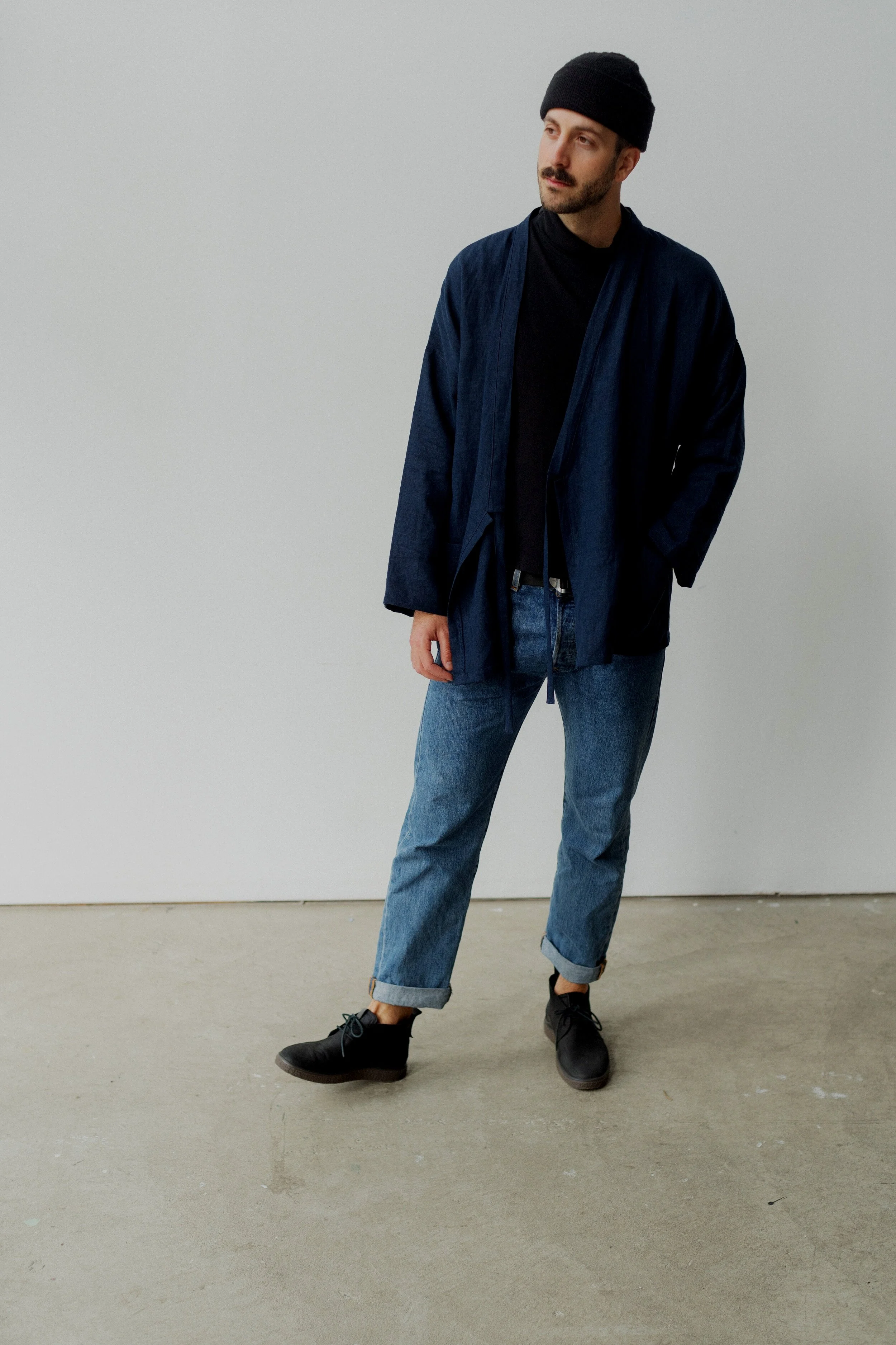 man wearing navy linen kimono jacket and black linen shirt open look
