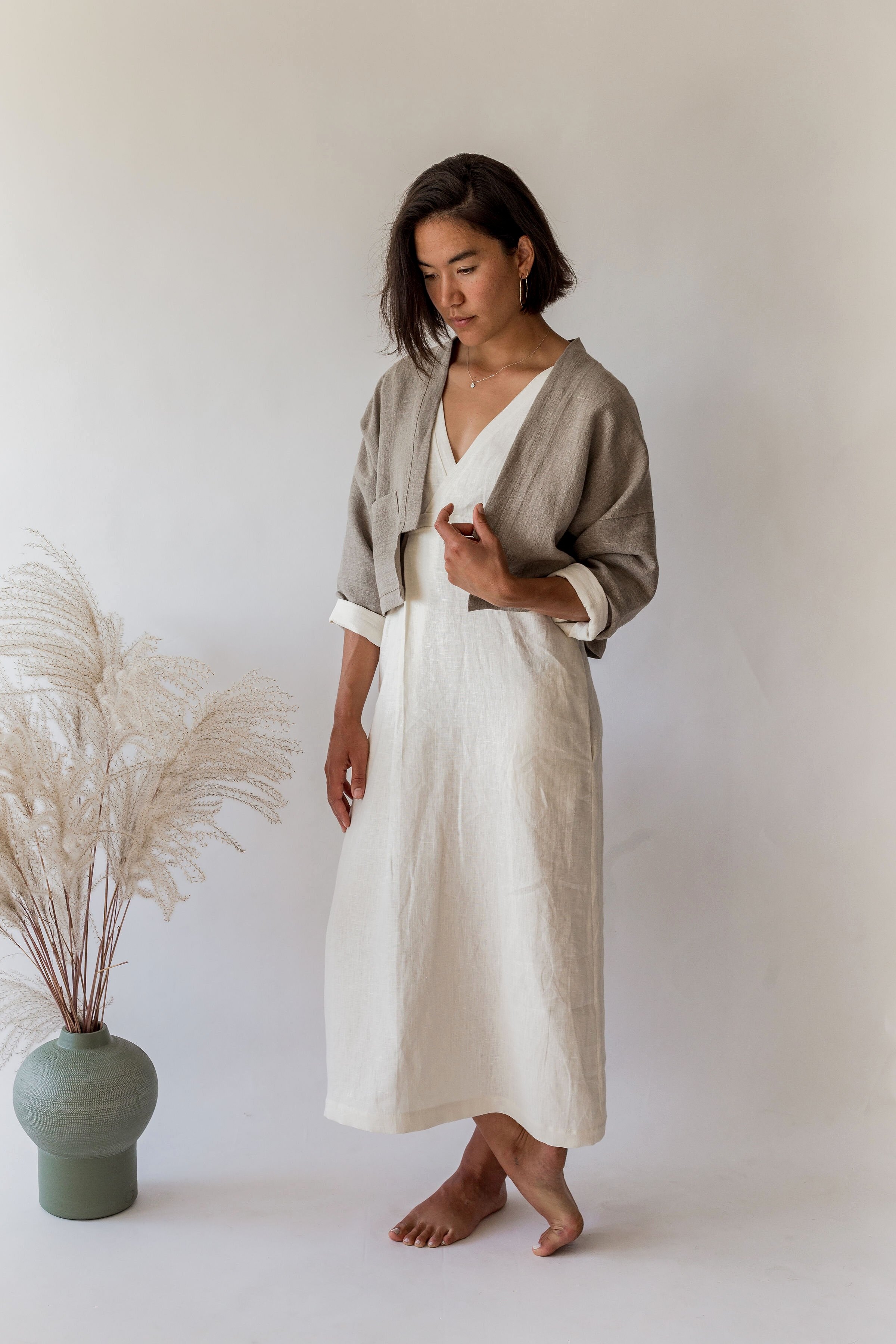 woman wearing ivory linen long-sleeve Nicole dress and natural linen jacket