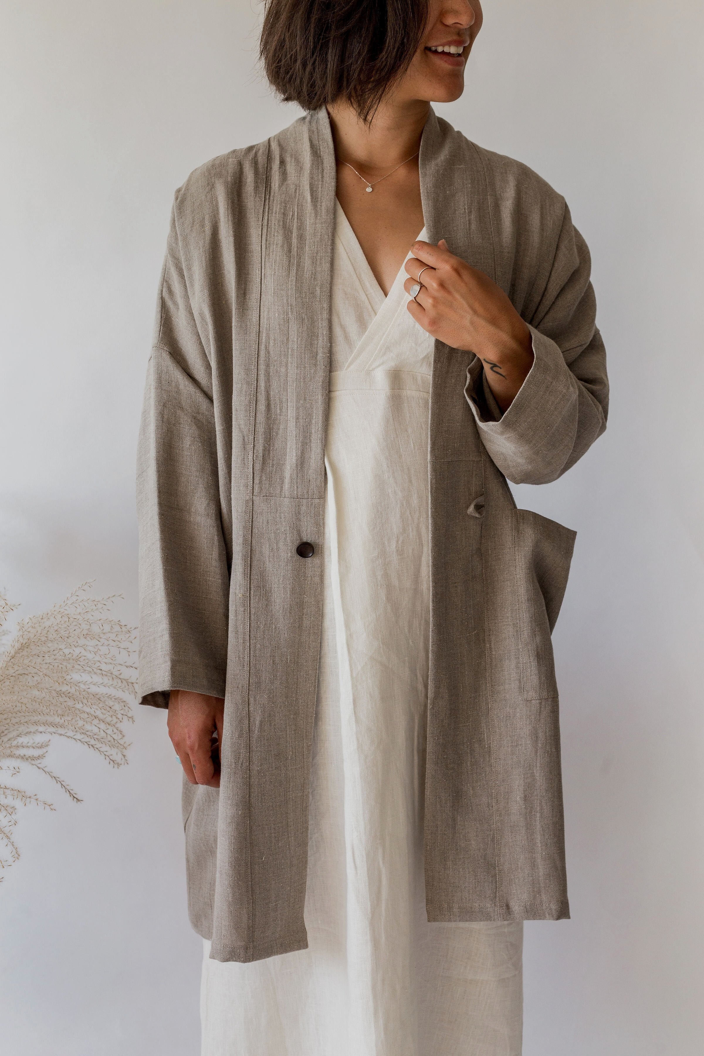 woman wearing natural linen kim coat and ivory linen dress