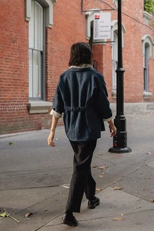 back view of woman wearing bella linen blazer cotton lined with elasticized back in black
