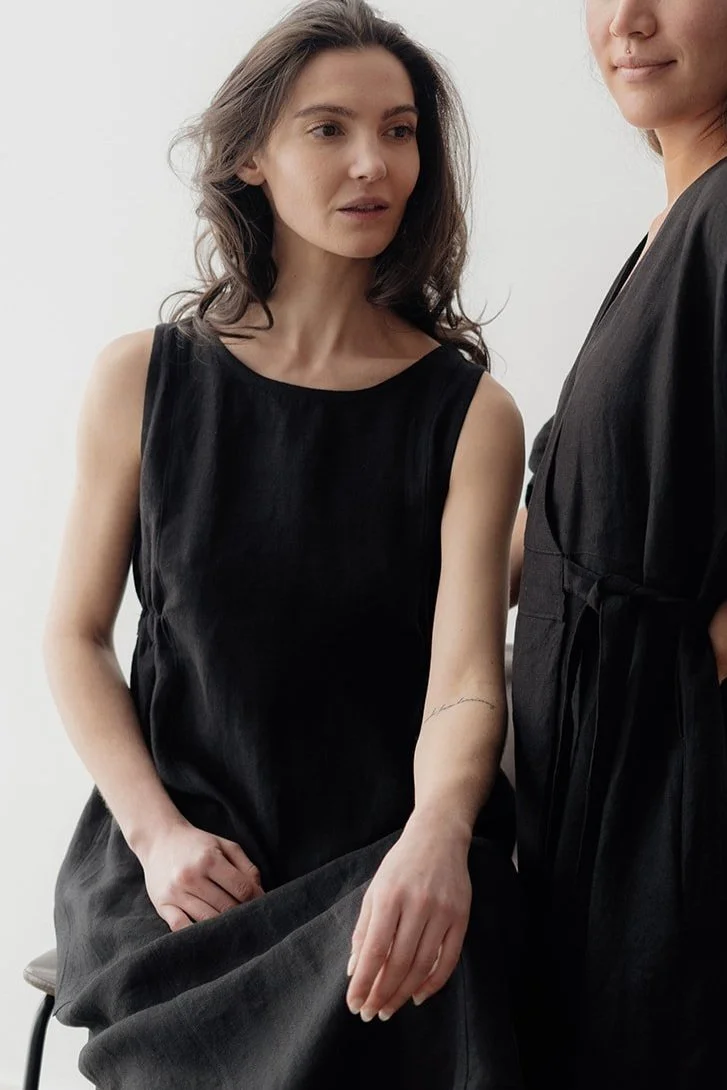 Front view of model wearing the Roz linen dress one in black with front pockets