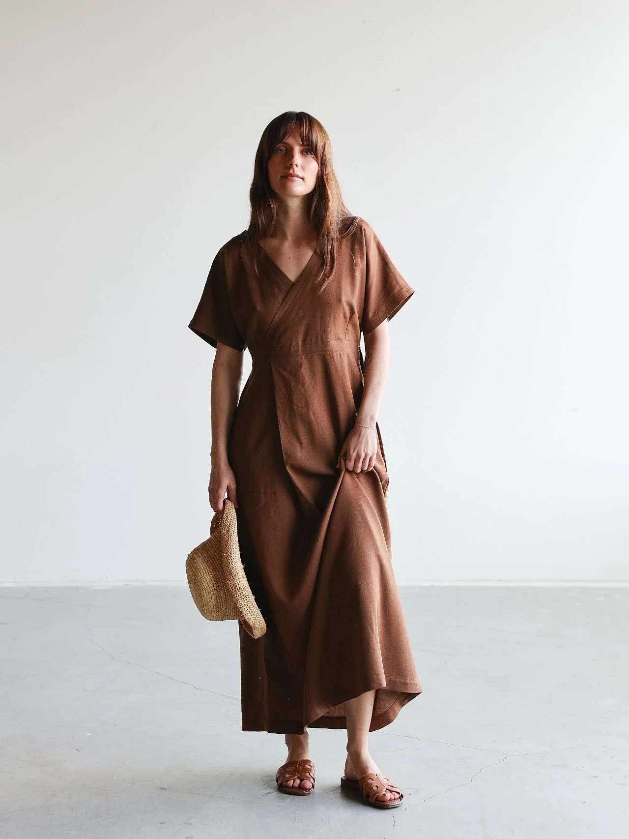 The Nicole Dress features a soft, flowing silhouette with front and back v-necks, a flattering empire waist, and roomy side pockets. Gentle pleats and a stretchy back add a touch of romantic drama while creating an easy, comfortable fit. 
Perfect for