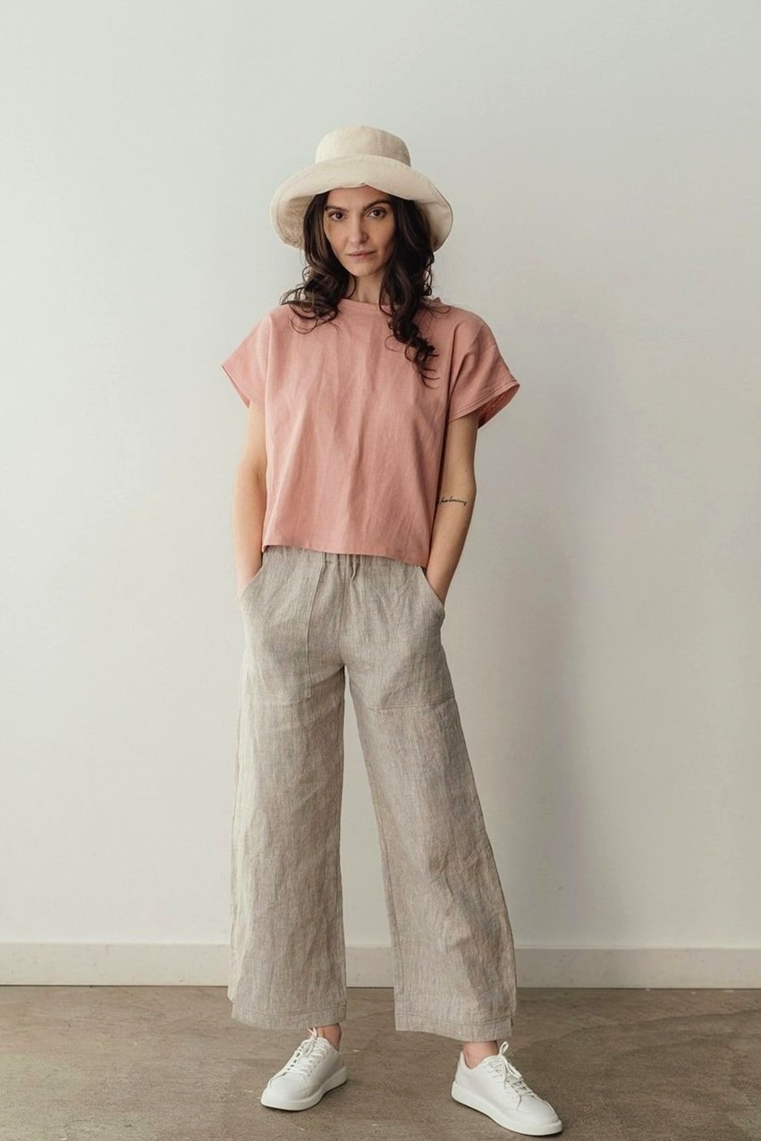 Front view of model wearing the Jessie linen top by Nomi Designs in pink with hands in pockets