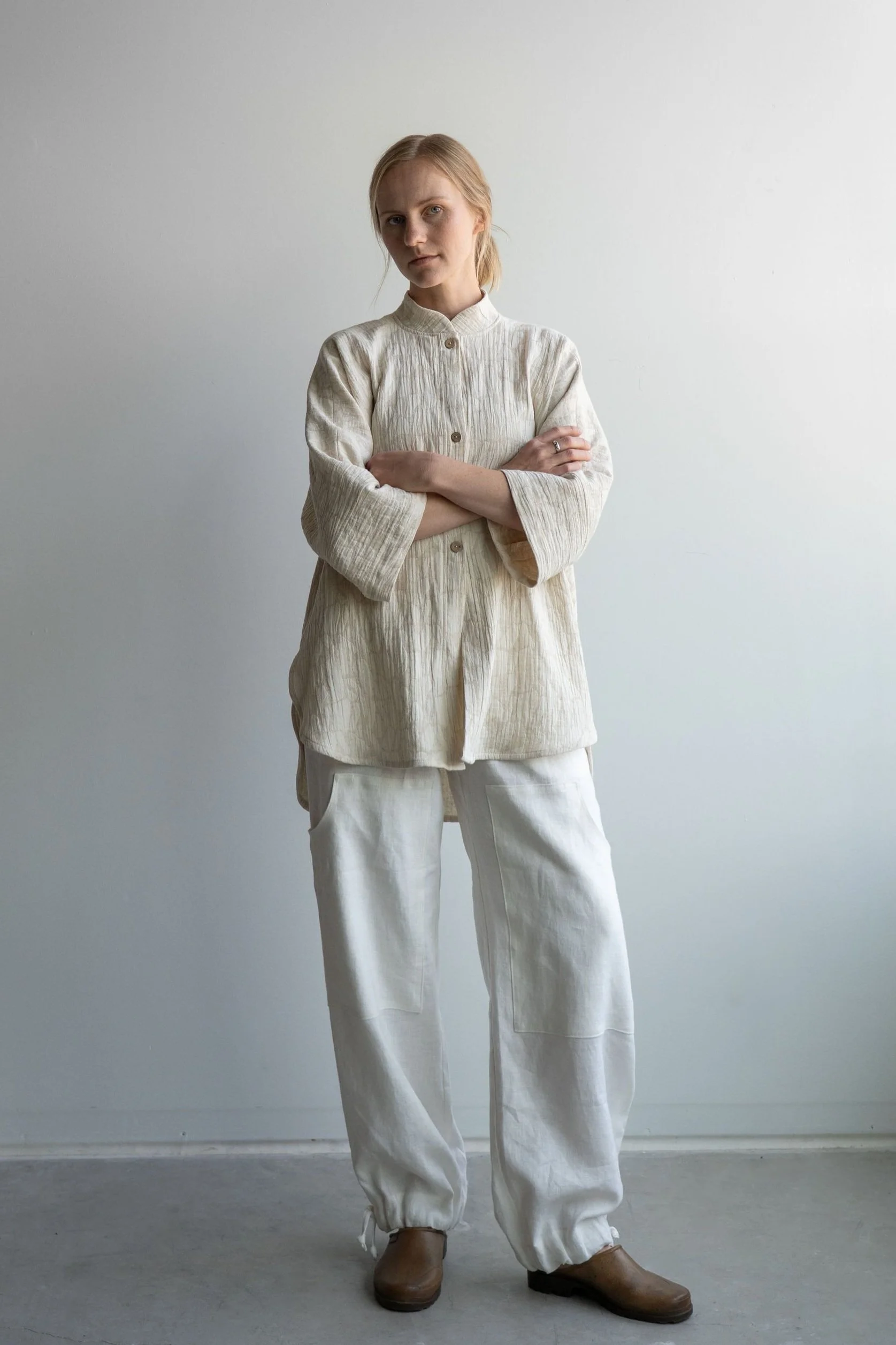 Woman wearing ¾ Sleeve linen button-up shirt in oatmeal standing