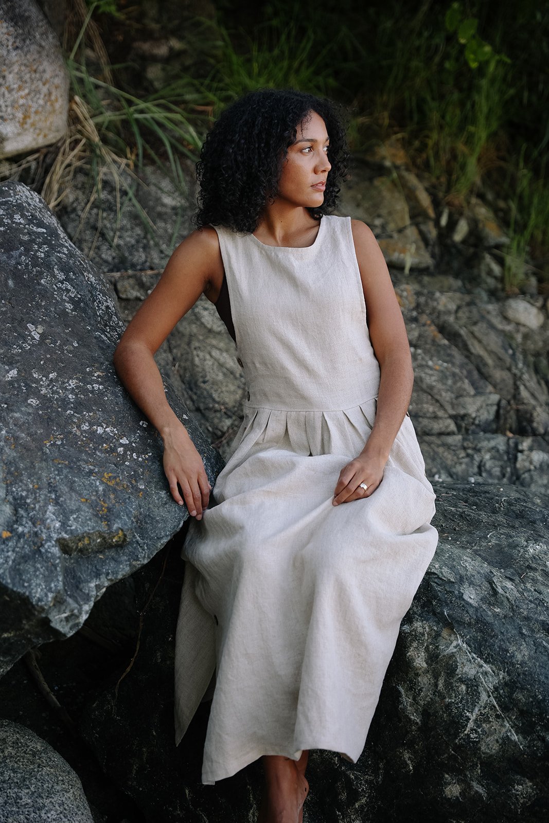 nomi-designs-linen-dress-natural-sit-front-Beach.jpg