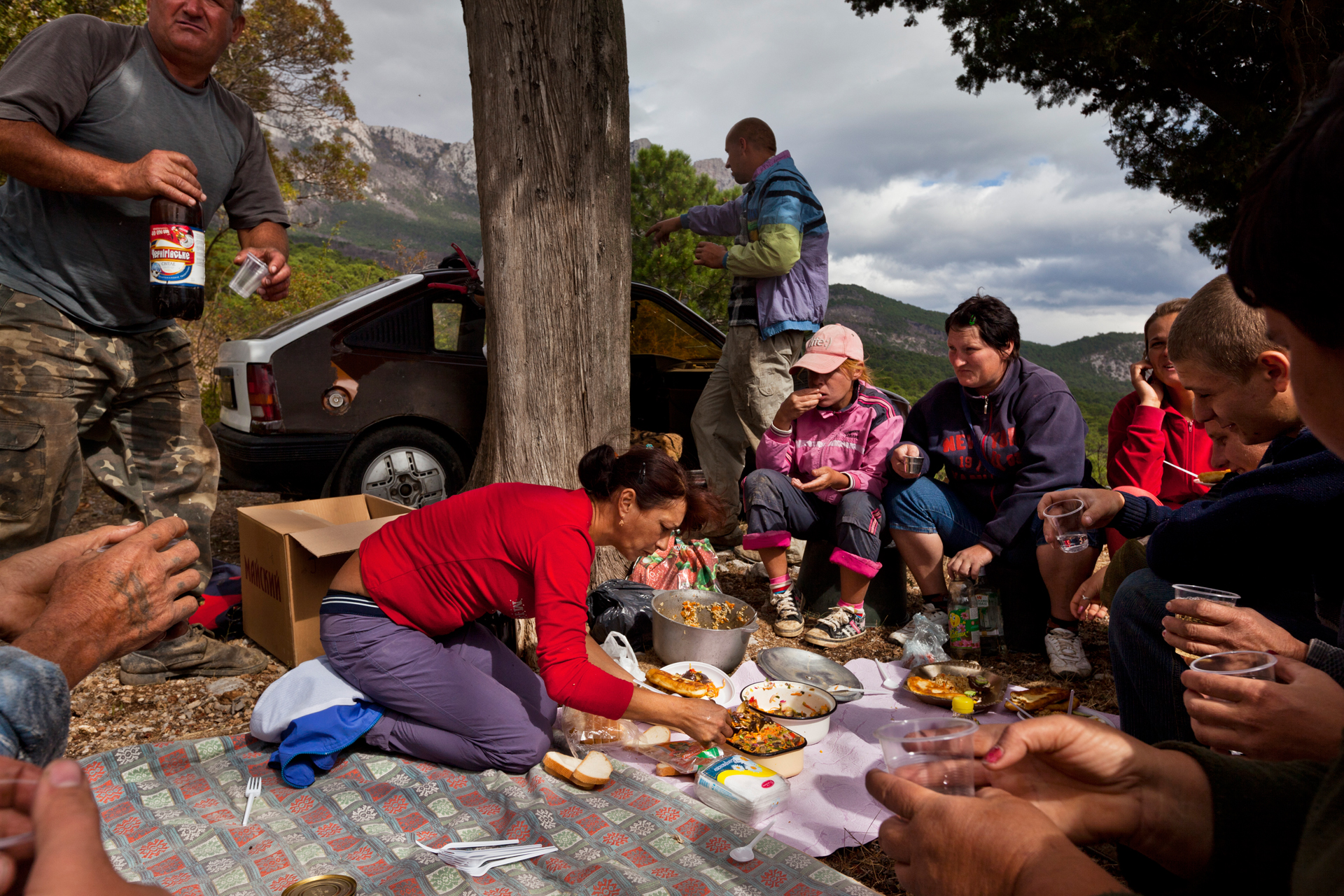  A group of hired grape pickers break for a bucolic lunch in the vineyards near the Crimean coastline.  Near Yalta, Crimea  
