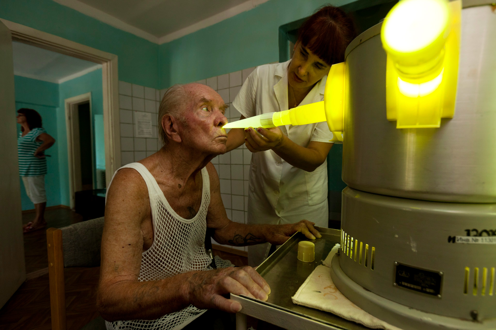  A specialist at the Veteran Santorium in Alushta assists an ailing patient with the inhaler, used to treat respiratory diseases. Patients at this state-owned sanatorium are the beneficiaries of what's left of a Soviet system that ensured each citize