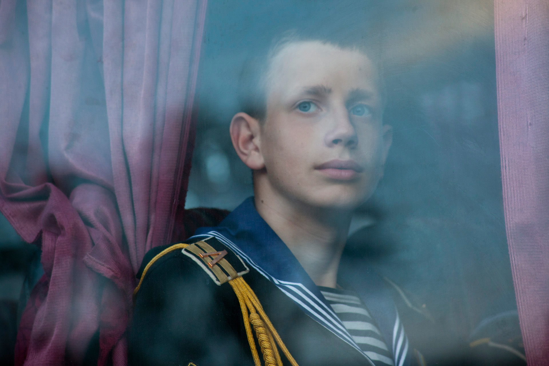  Yuri Perov, a Ukrainian naval cadet, takes the bus to his barracks after rehearsal for the Victory Day parade. To remember the sacrifice of fallen soldiers is viewed as a holy duty in Sevastopol, which endured a 247-day-long siege by Hitler's army i