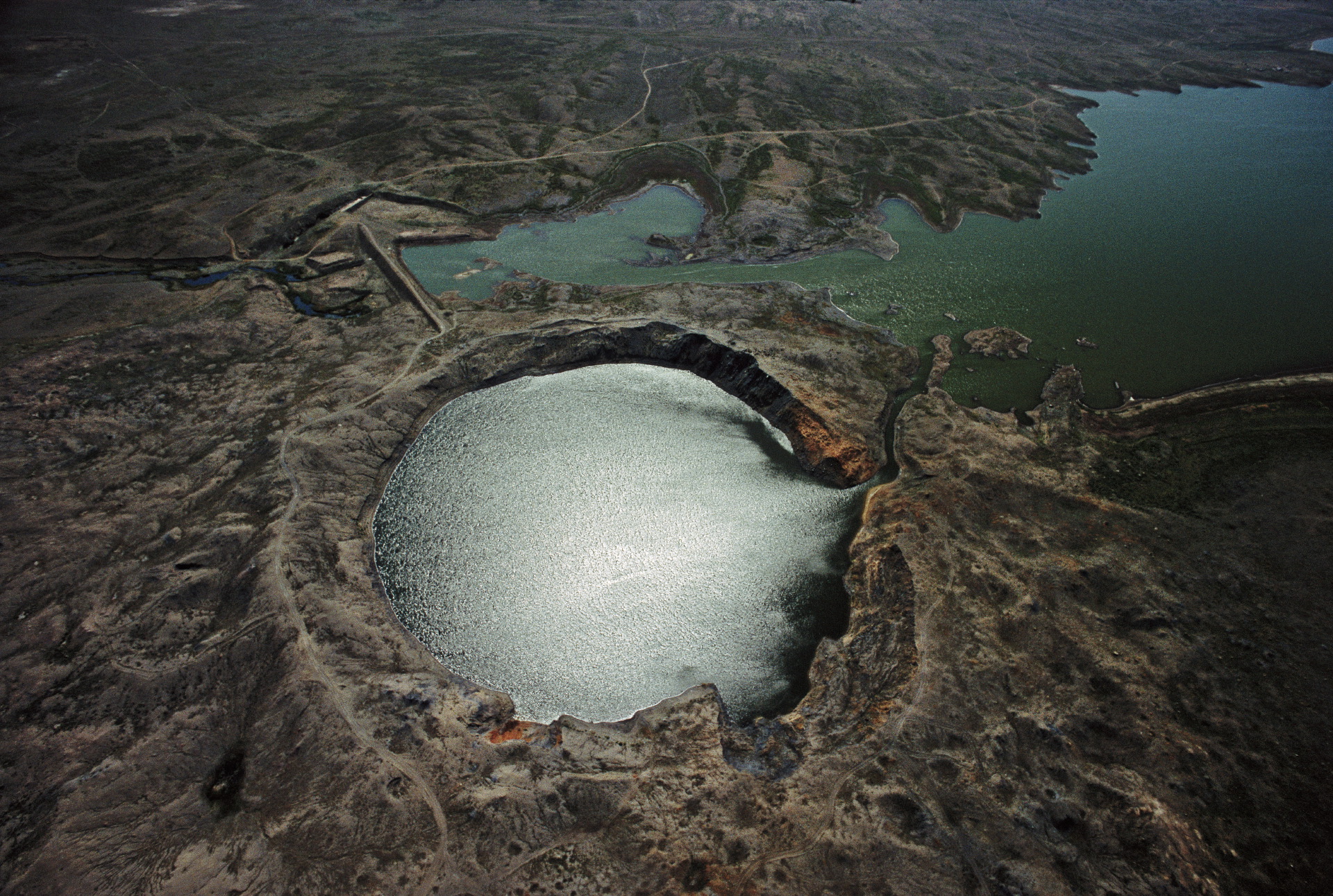  The largest and most notable "cratering shot" detonation following the Partial Nuclear Test Ban Treaty took place in 1965 at the Chagan nuclear test site in Kazakhstan. Large amounts of radiation were vented when this reservoir (also known as "Atomi