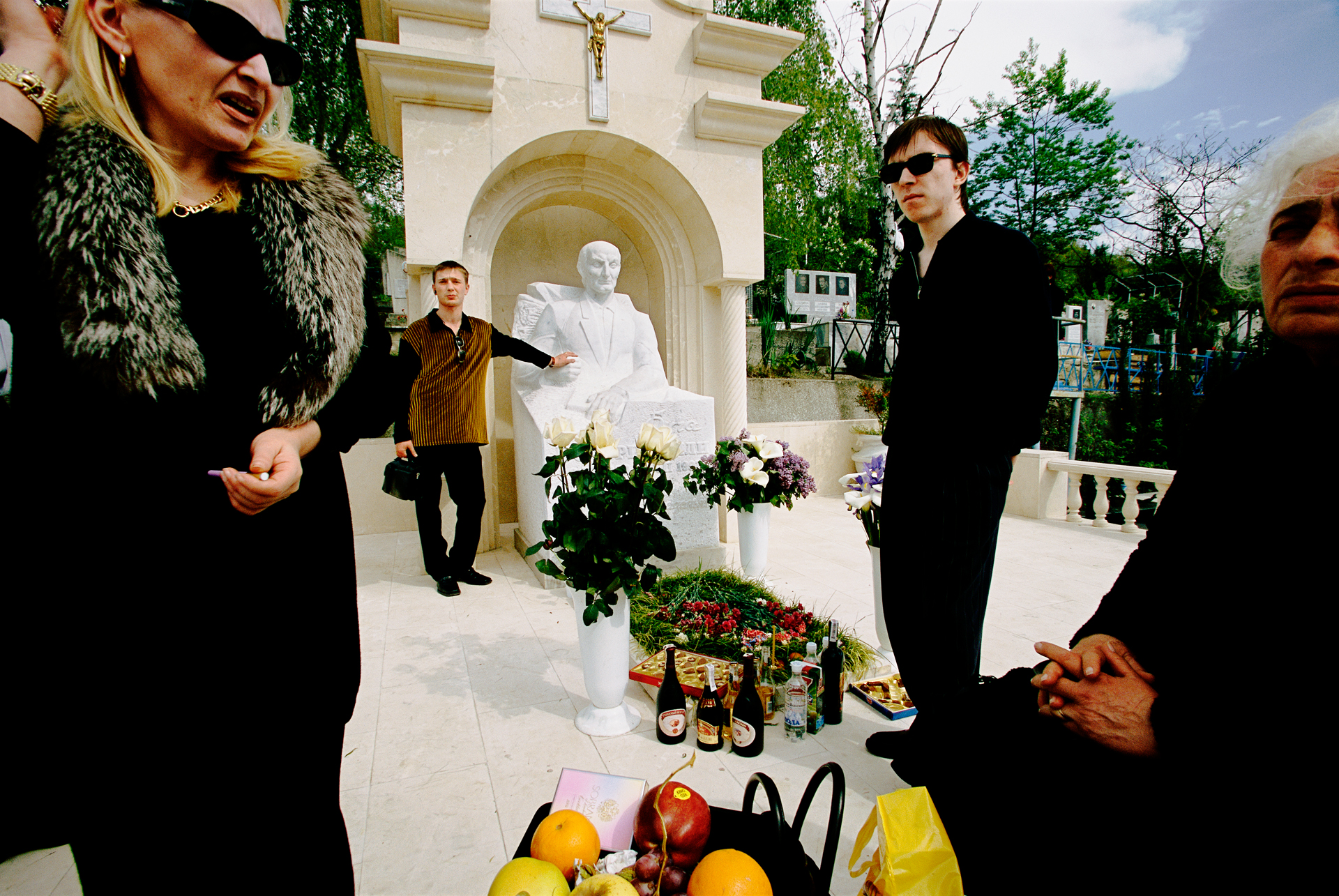  New Russians – probably part of the affluent mafia crowd – honor an old tradition: Gathering to wine and dine at the grave of a deceased relative on Parent’s Day.  Sochi, Russia  