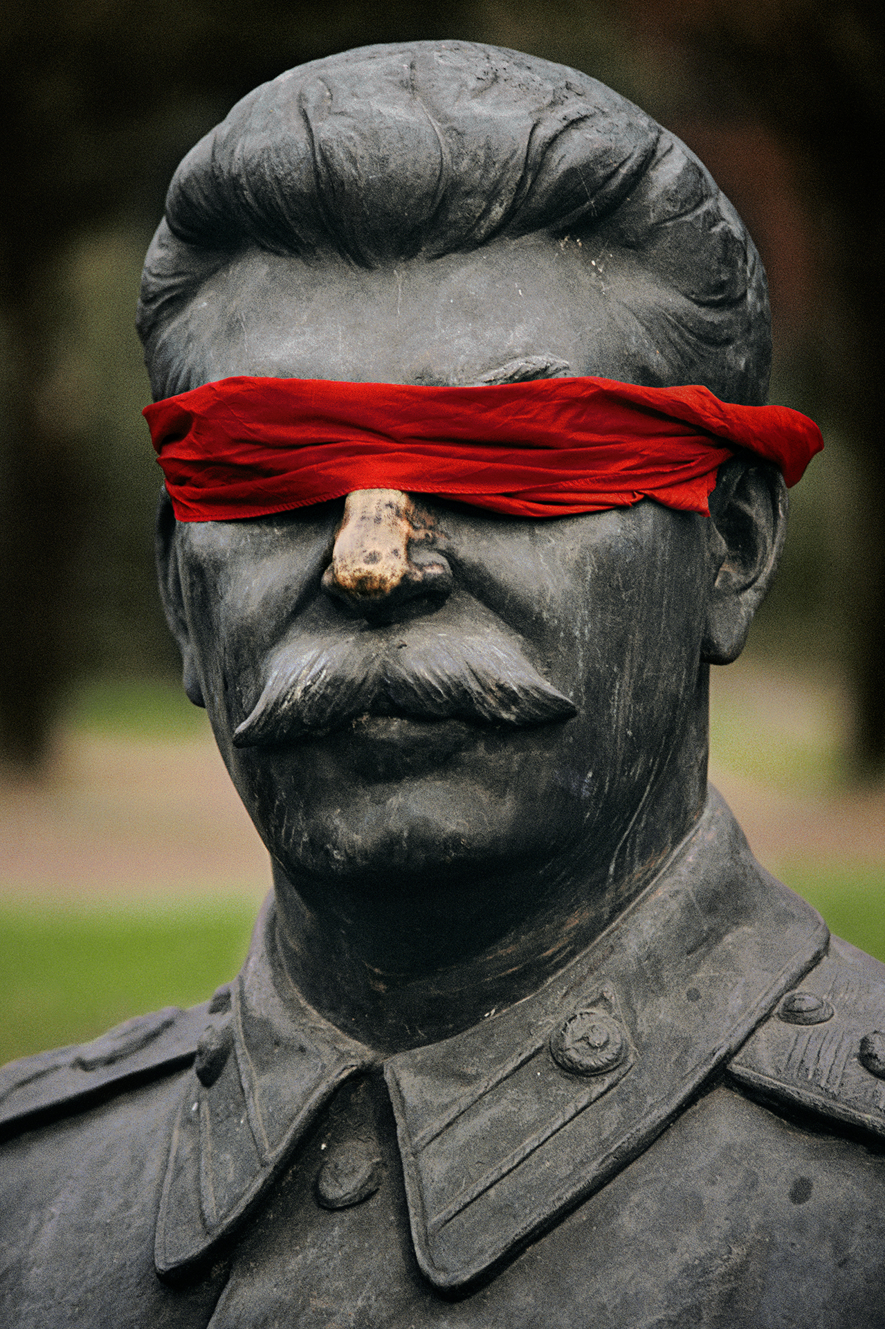  Blindfolded by a child, a statue of Stalin, most feared ruler of the communist era, sits amid other toppled effigies of party leaders now jumbled together in a Moscow park.  Moscow, Russia  