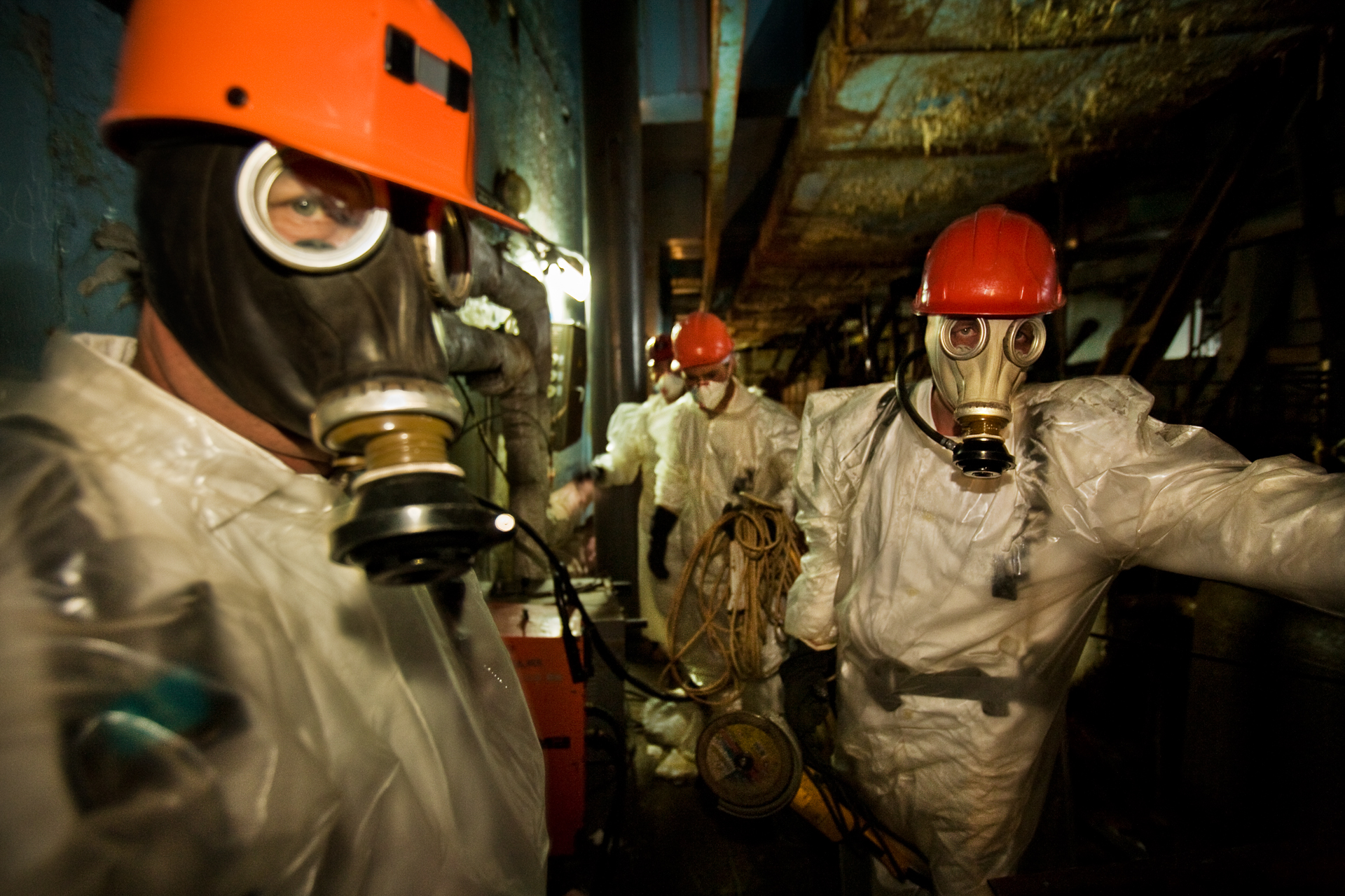  Chernobyl plant workers wearing plastic suits and respirators enter the so-called diarator stack, where radiation is so high that workers can risk shifts no longer than 15 minutes per day.  Chernobyl Nuclear Power Plant, Ukraine  