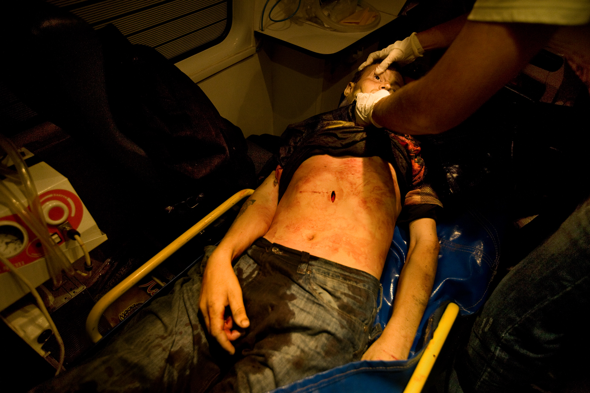  11:52 AM - Medical personnel examine a stab-victim discovered in a police raid in the eastern district of Moscow. 