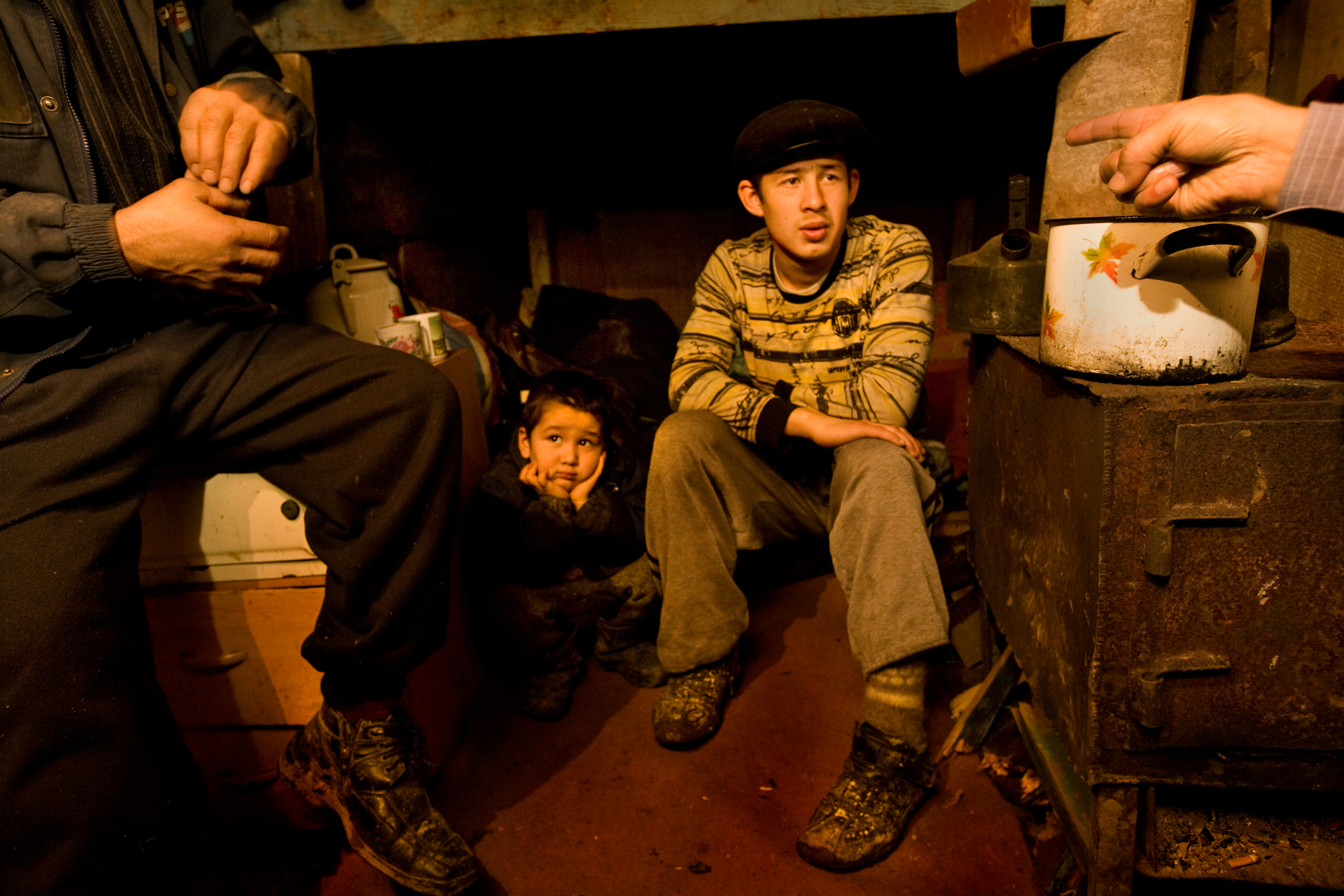  5:52 PM - A family in their bleak make-shift home in Chelobityevo, 'gastarbeiter' colony on the outskirts of Moscow. 