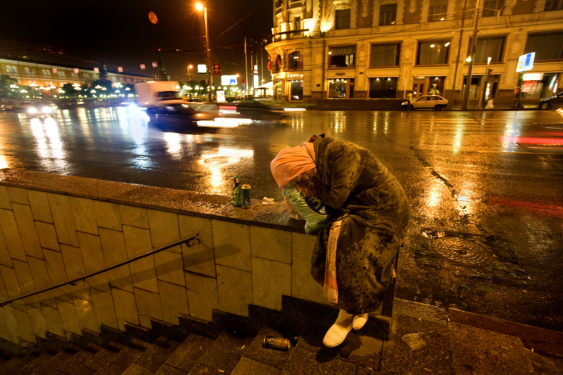  2:50 AM - A homeless woman sleeps on Tverskaya Street on a rainy Moscow night. 