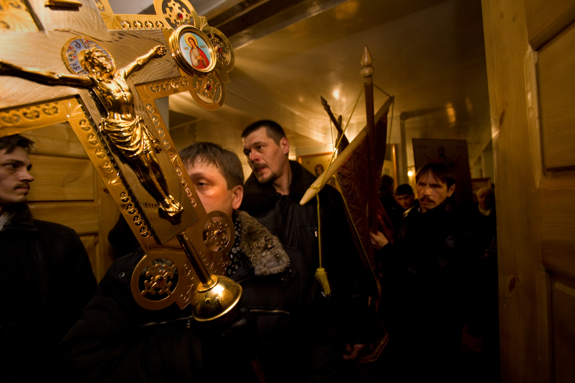  The weight of ritual intensifies on Easter Sunday as parishioners collect banners and icons for a procession before midnight Mass.  Vorkuta, Russia  