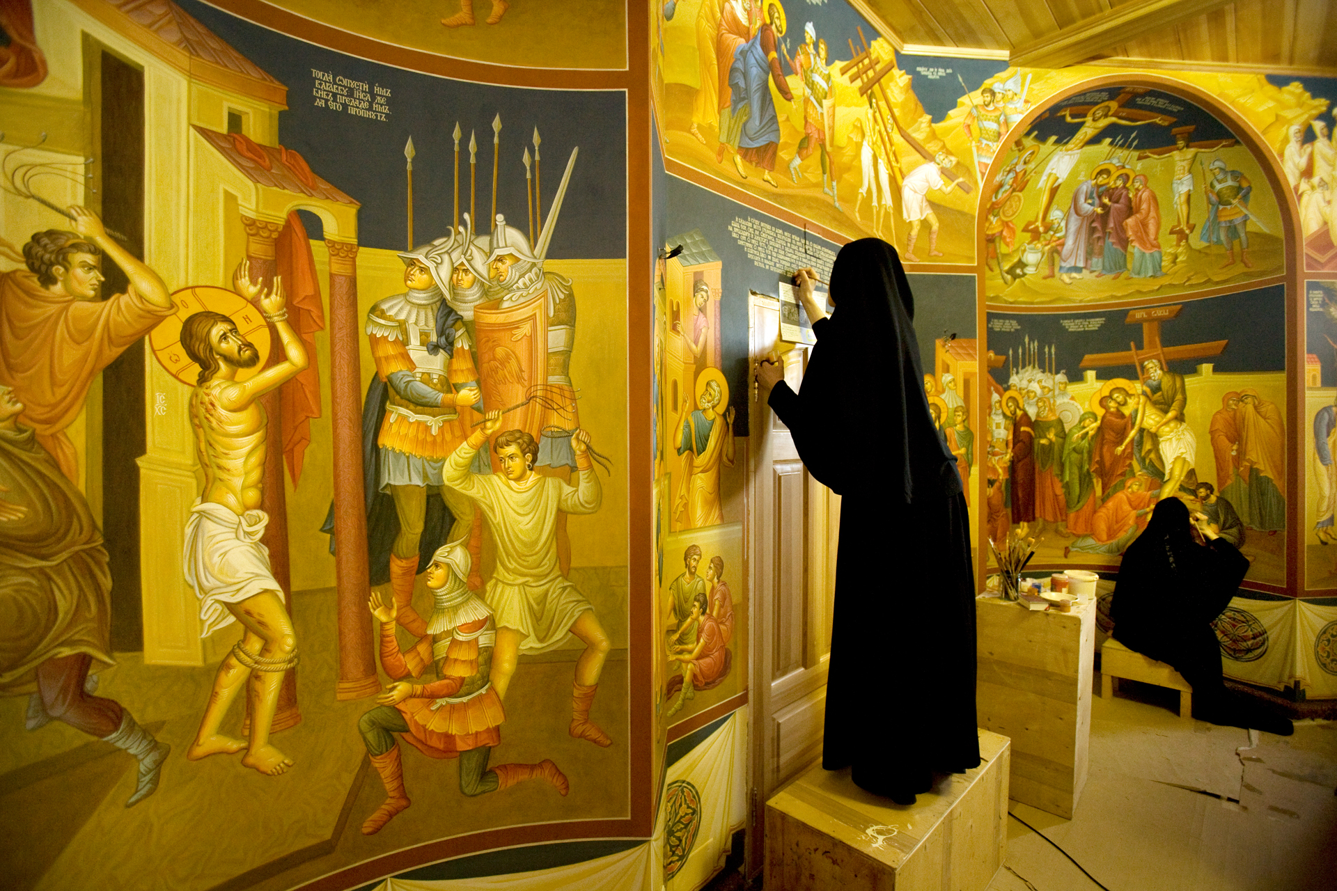  Novo-Tikhvinsky Convent nuns paint walls with religious motifs in a cloister complex that will serve as their abbot's future residence.  Yekaterinburg, Russia  