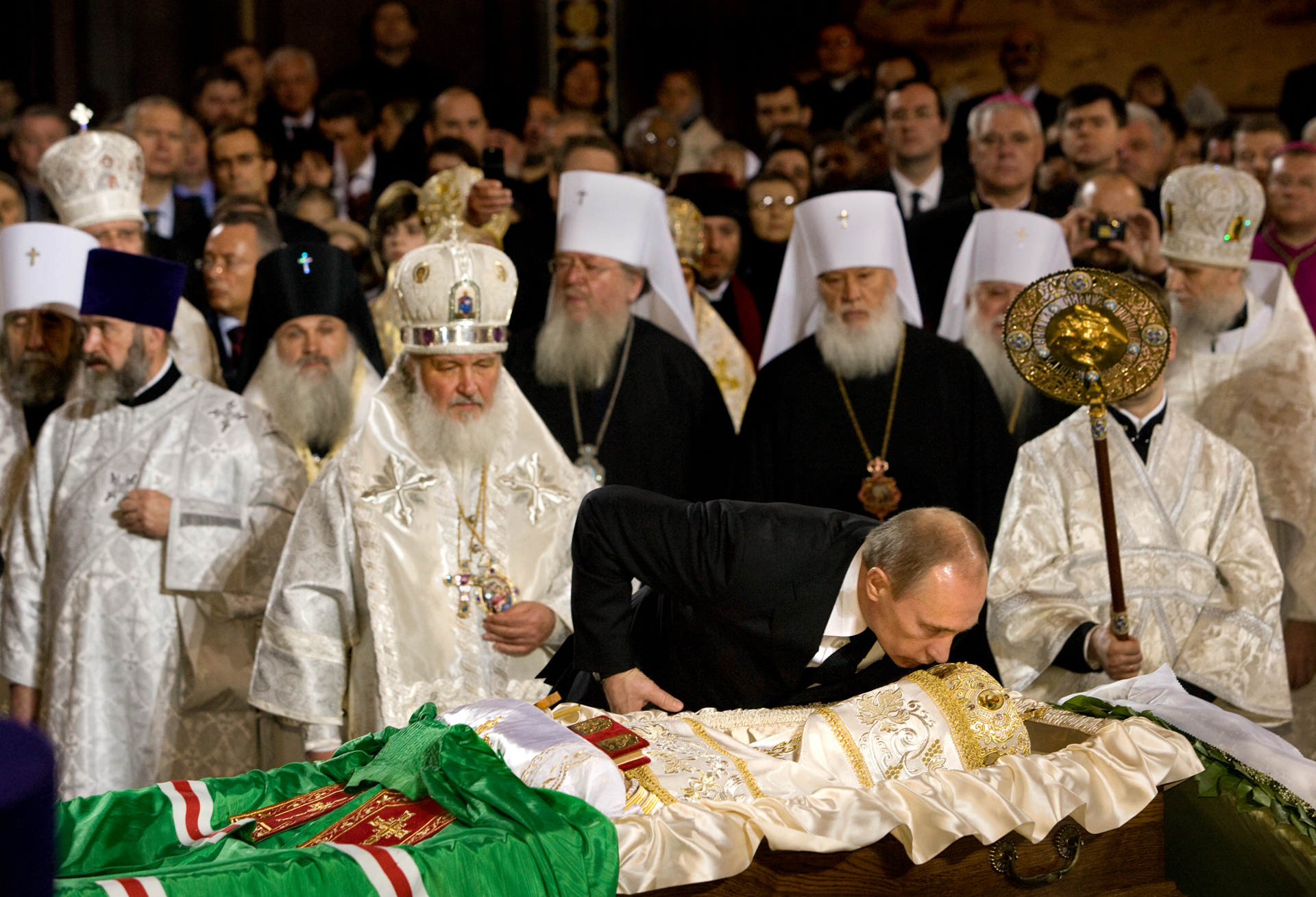  At the funeral of Alexy II, Prime Minister Putin kisses the body of the late patriarch while the successor, Metropolitan Kirill stands close.  Moscow, Russia  