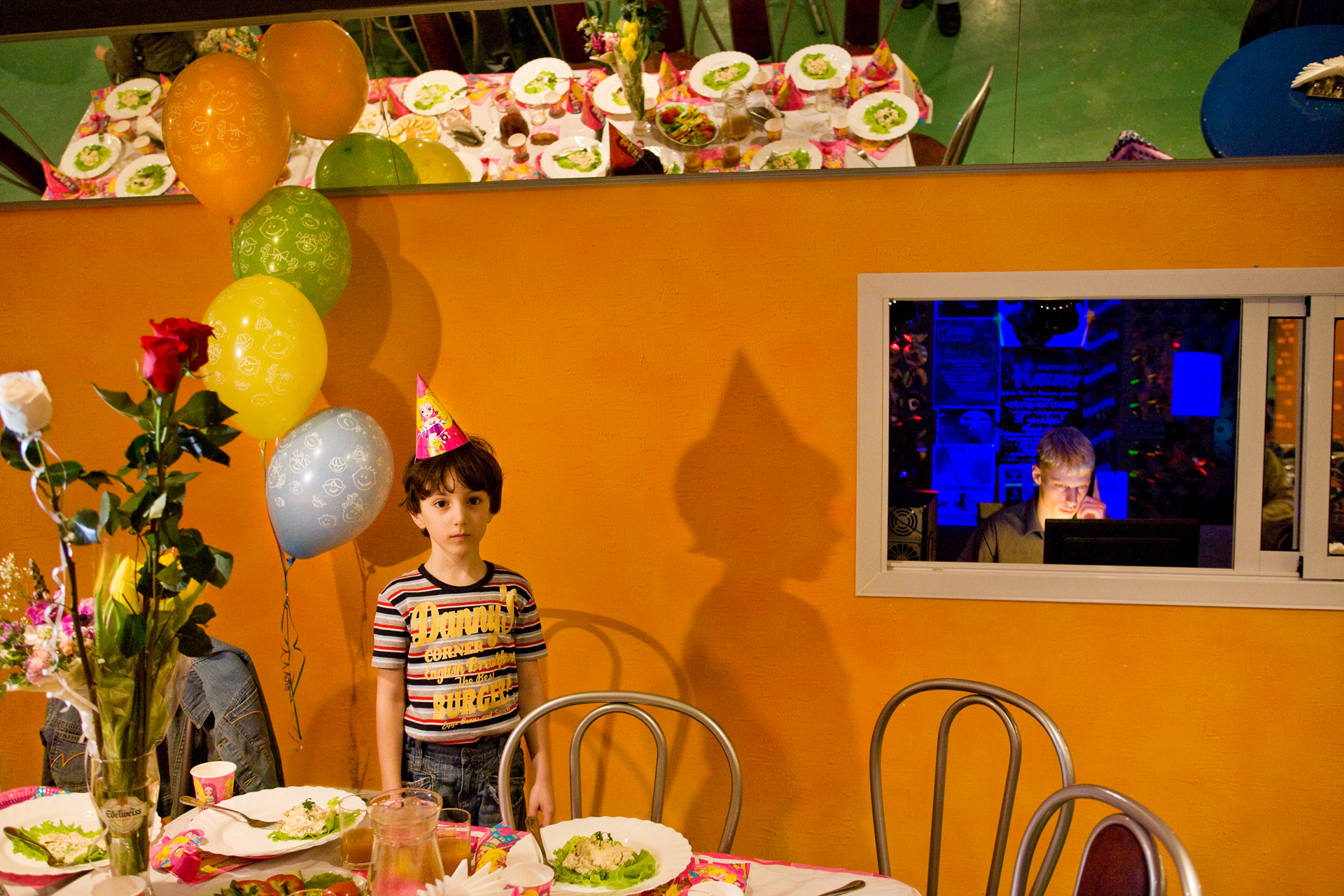  Overwhelmed by a lavish birthday party at the new Orange Parrot Entertainment Center, a young guest pauses during the state-of-the-art celebration.  Surgut, Russia  