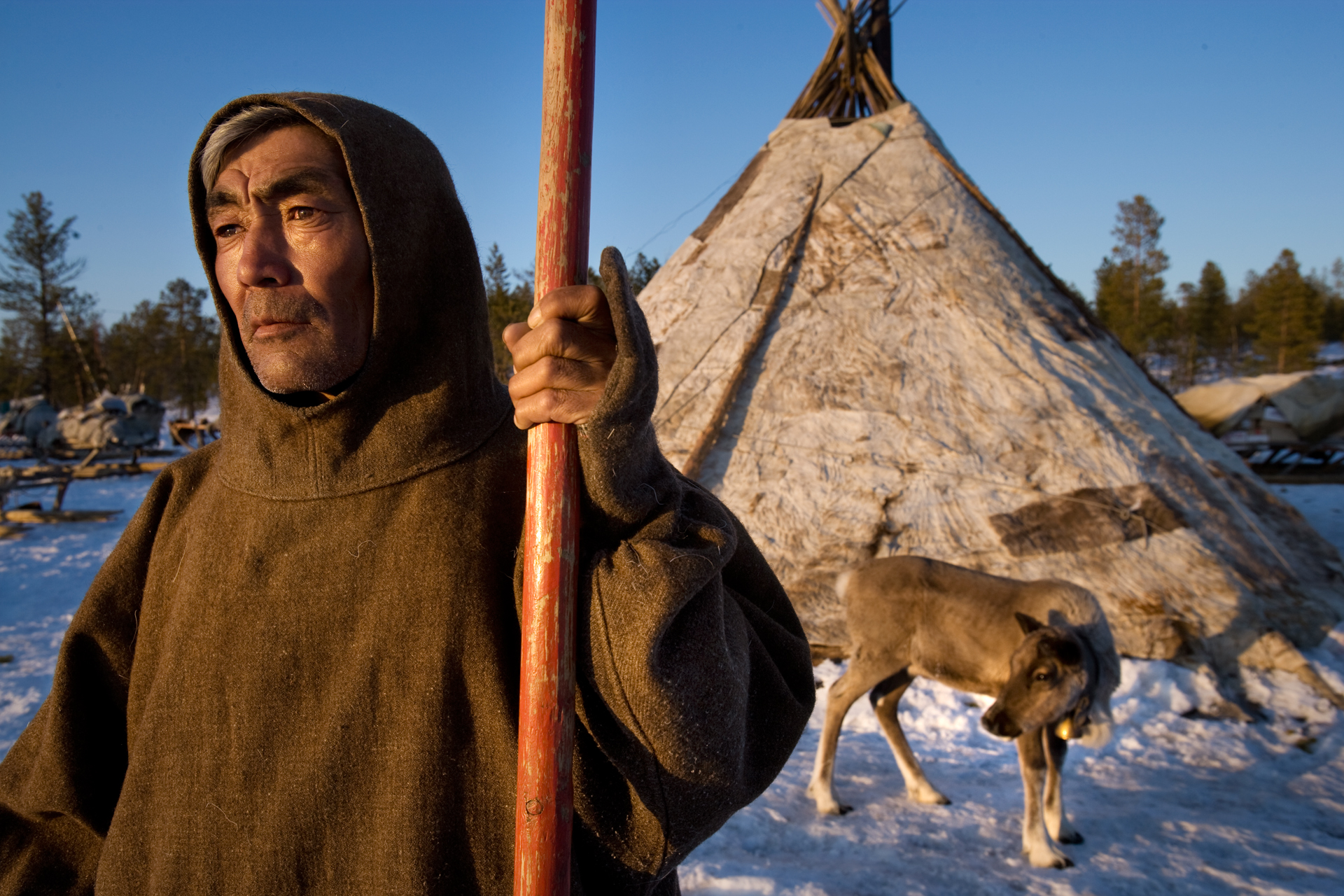  Nenets herder, Alexander Turgachev, in front of his brigade’s chum - a traditional dwelling (yurt) made of reindeer skins.  Near Saranpaul, Russia  