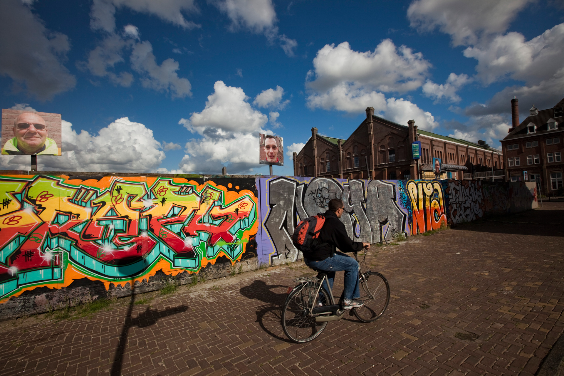  A cyclist bikes past graffiti at the corner of Linnaeusstraat and Praetoriusstraat in Amsterdam. 