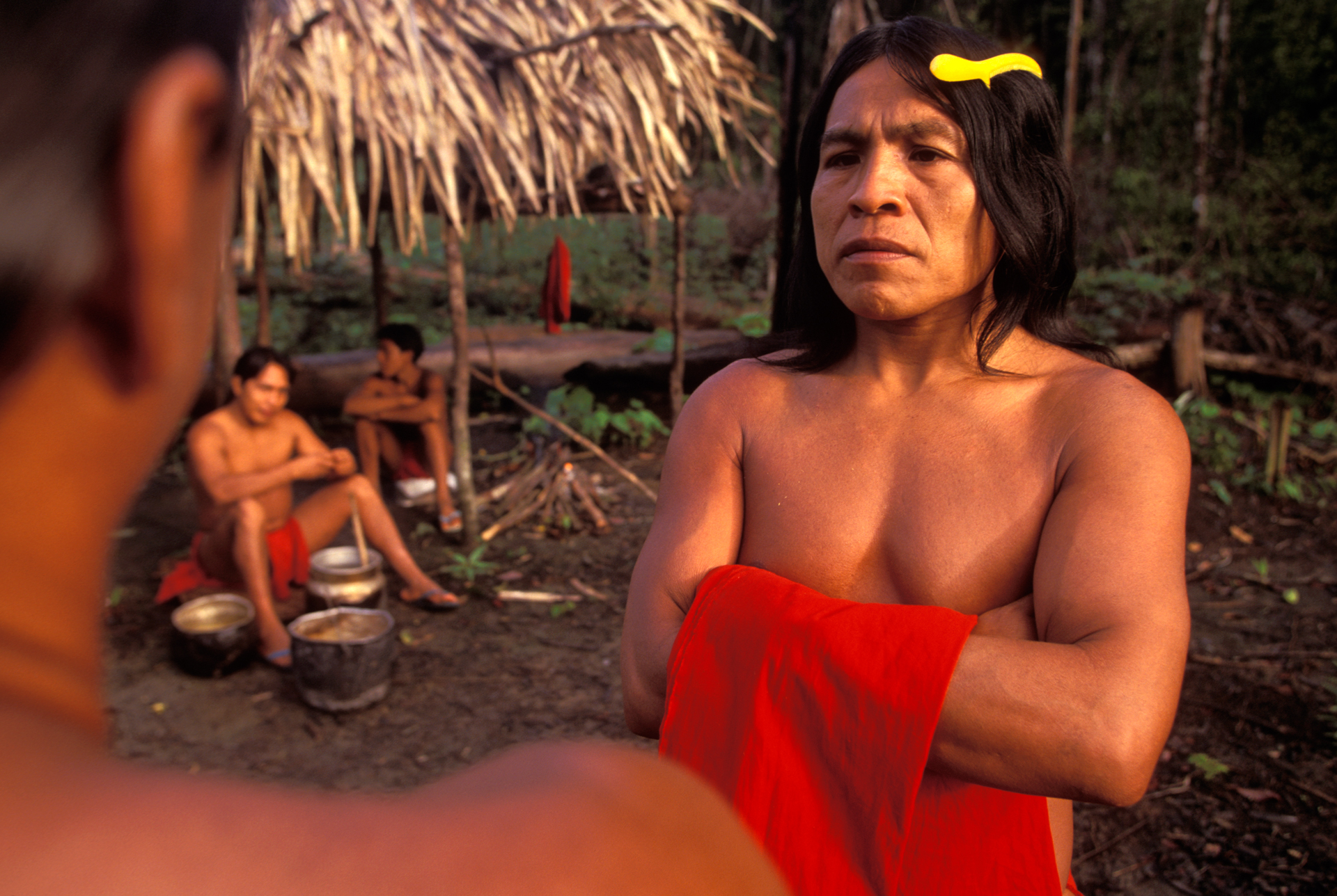  Kumare, chief of the Waiapi, listens attentively. A yellow plastic comb and the red loincloth are some of the visible influences from western culture.  Ari, Brazil  