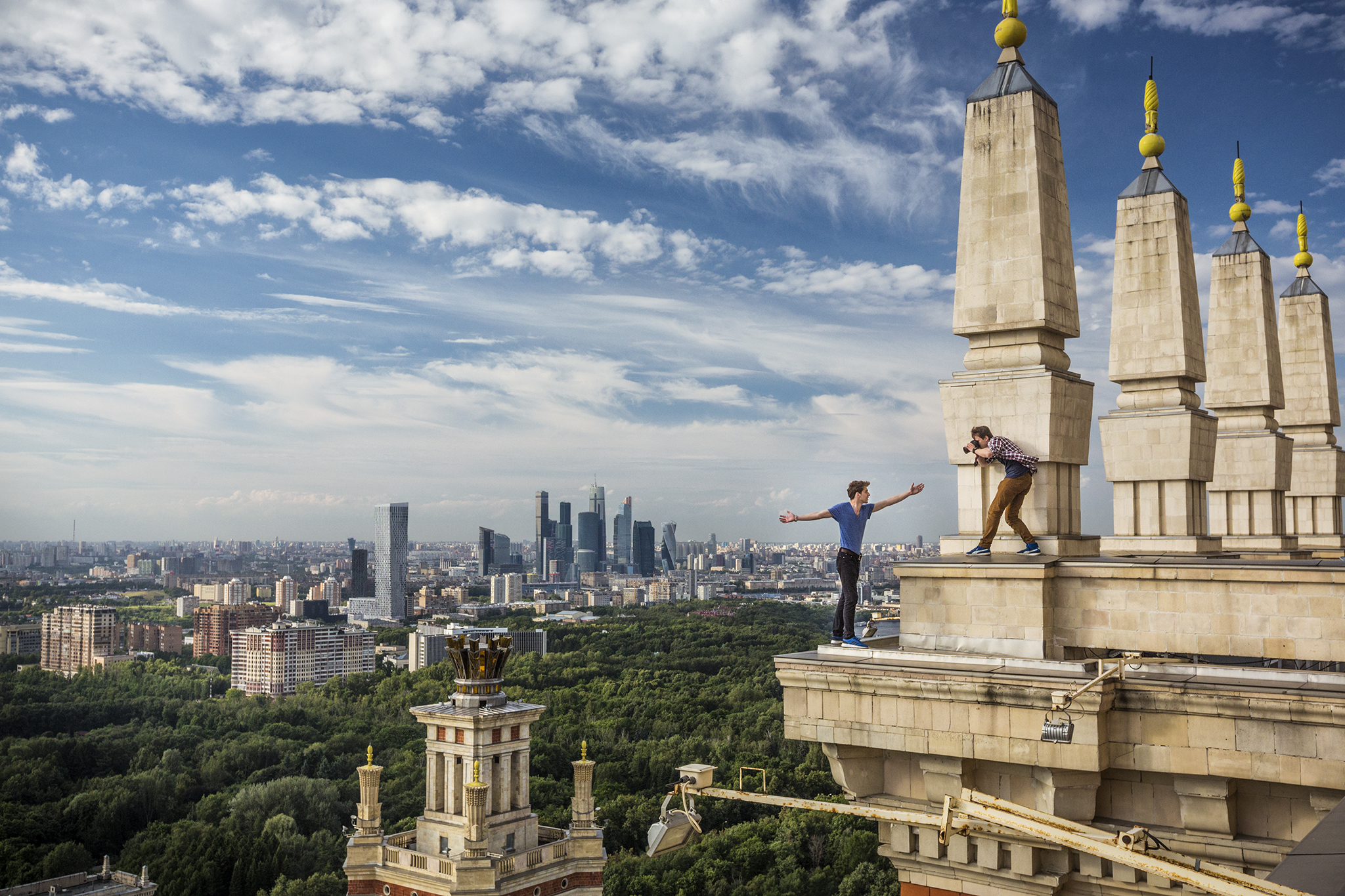  Kirill Vselensky perches on a cornice in Moscow as Dima Balashov takes his photograph to celebrate their adventures on Instagram. The 24-year-olds are prominent members of the city's death-defying "roofer" or skywalker community. They scale Russia's