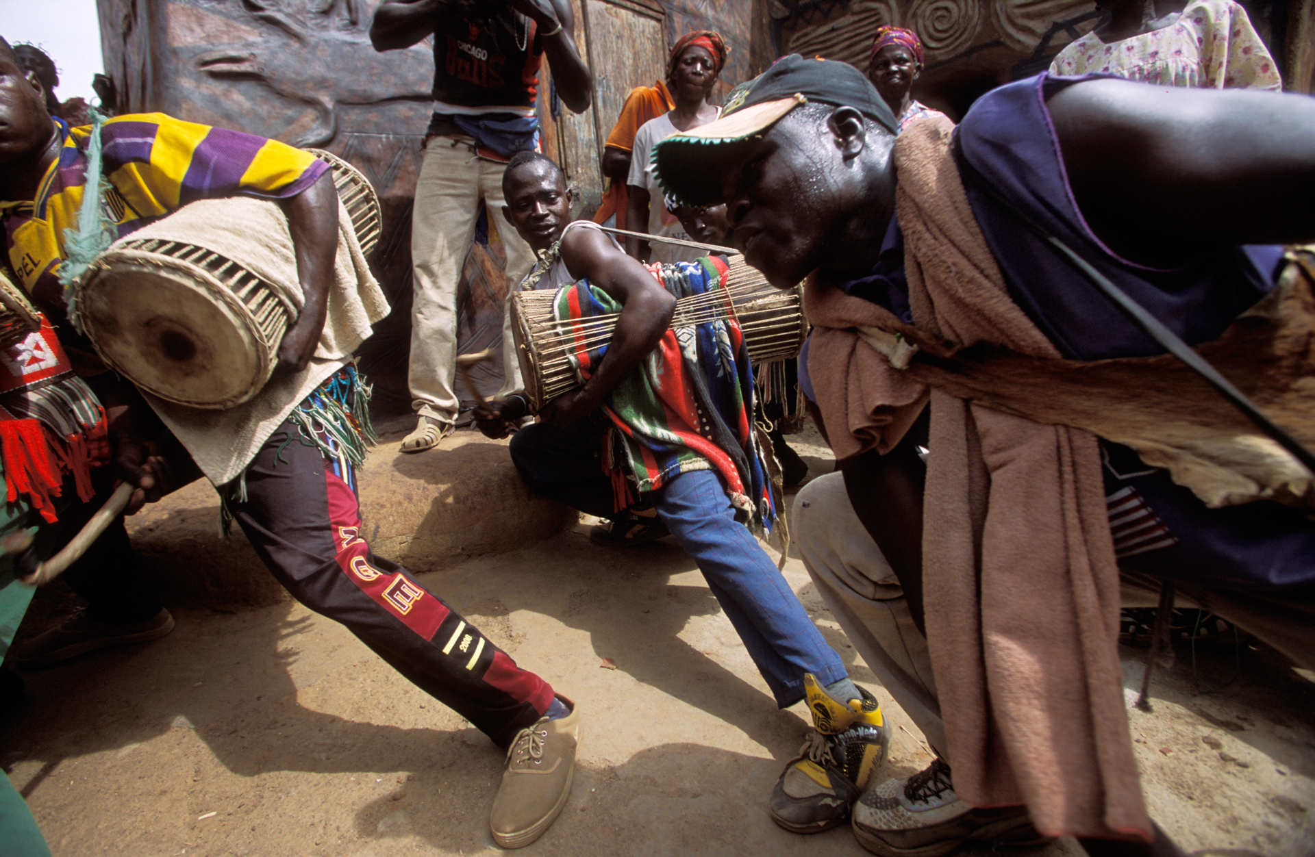  Gurunsi drummers give a highly charged street performance to start the "House Painting Day", which is part of the Tiebélé arts festival.  Tiebélé, Burkina Faso  