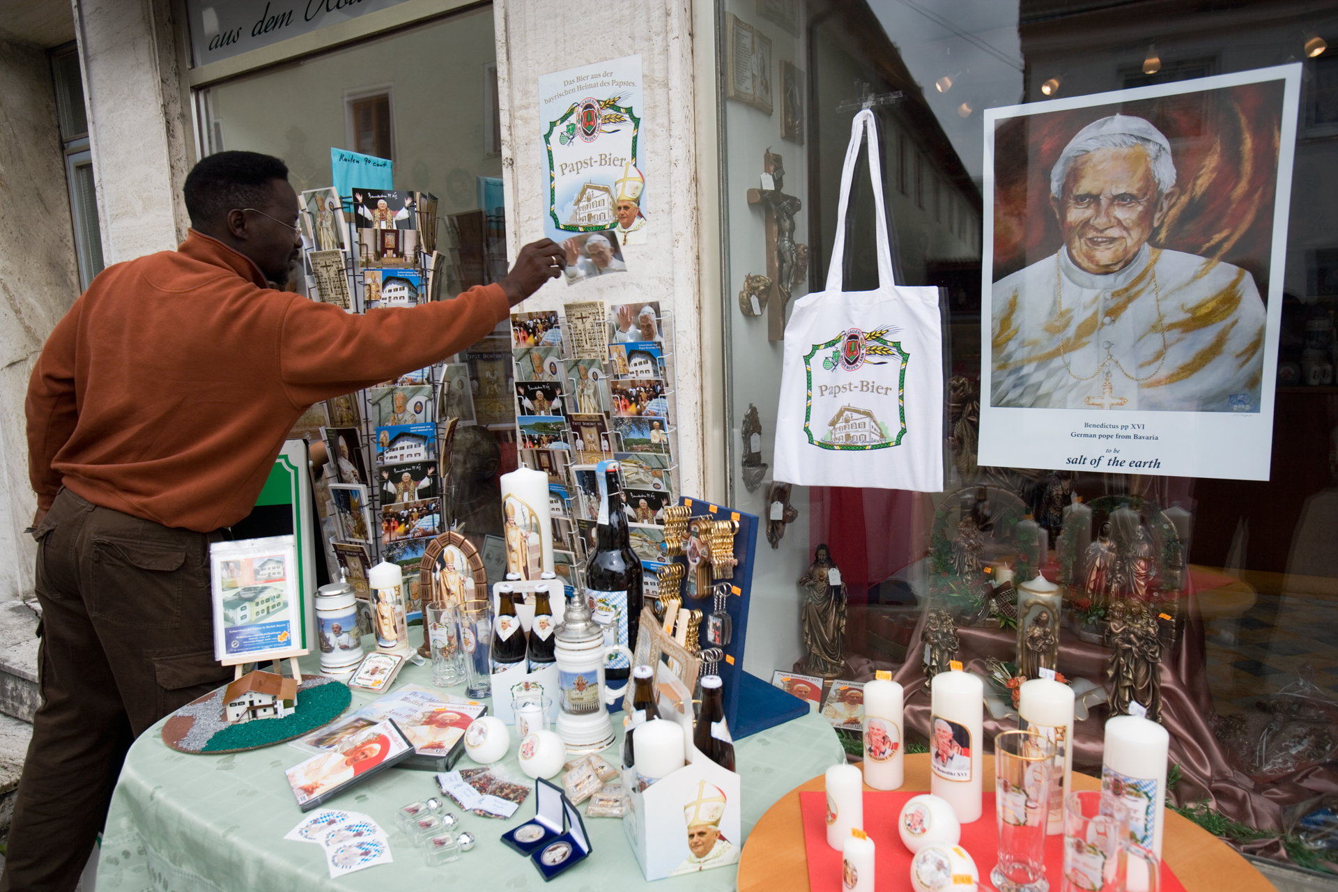  Visitors can buy Pope postcards, Pope posters, Pope candles, Pope key rings, Pope pastries, Pope candy, Holy water with the Pope's image, Pope beer, Pope wine, Pope T-shirts, and more.  Marktl, Germany  