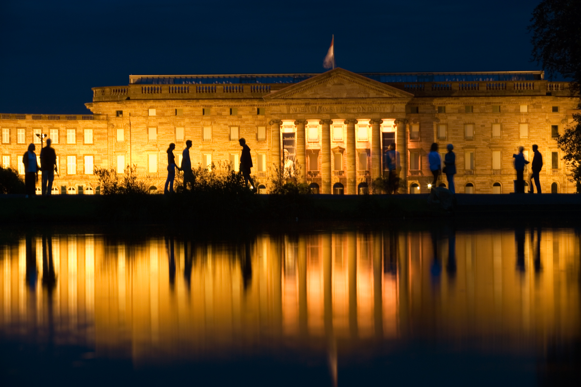  As evening descends, the lights of the Schloss Wilhelmshöhe are reflected in a small park lake.   Kassel, Germany  