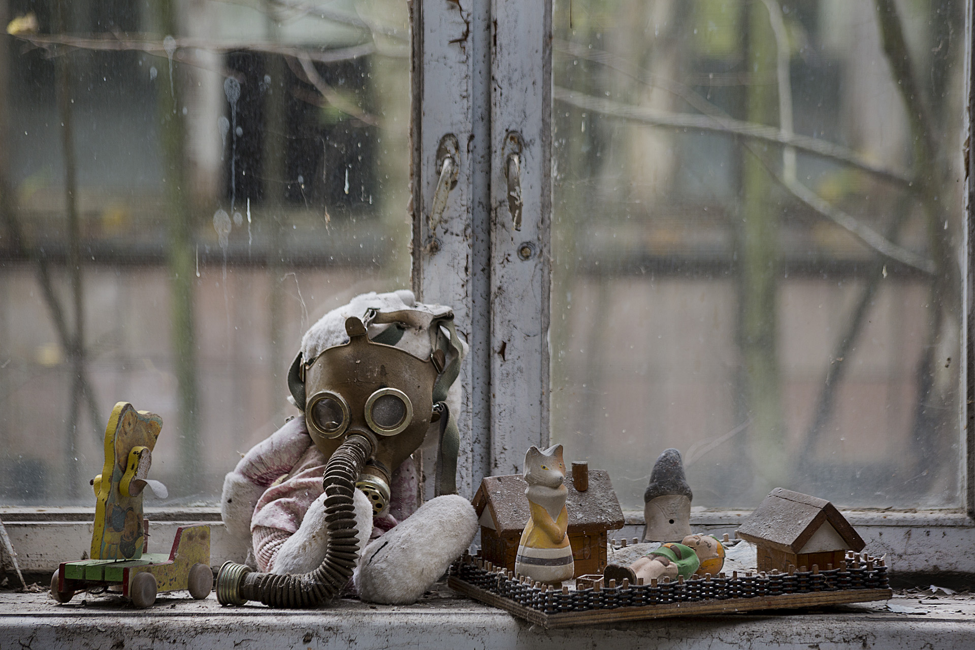 In an abandoned kindergarten children's toys and gas masks create a strange still life. One can suspect that the mix was created intentionally.  Pripyat, Ukraine  