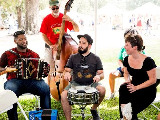Zydeco musician Lil Nate, left, discusses and demonstrates his creative process May 27 at the Blue Moon Saloon during the South Louisiana Songwriters Festival. (Photo: David Simpson)