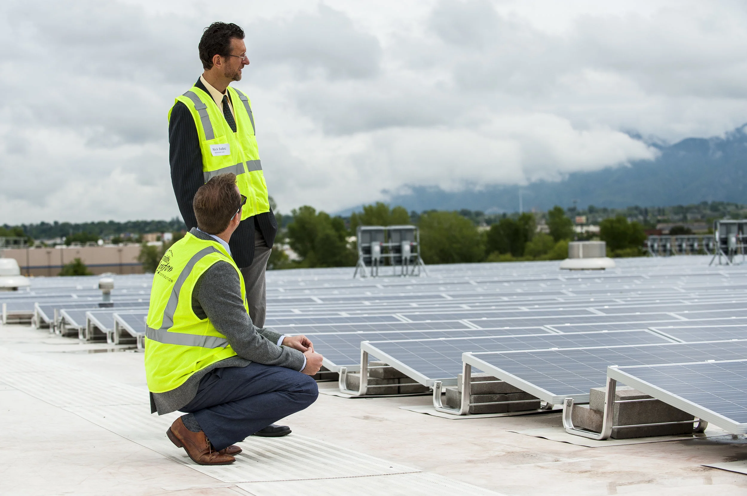 Nick Babic and Kevin Bassalleck of Affordable Solar look over the 4,066 solar panels that their company was responsible for installing on the rooftop of Smith’s Food and Drug Distribution Center in Layton on May 19, 2015. The project is the second largest in the state of Utah and the panels will cut the center’s energy consumption by 20%.