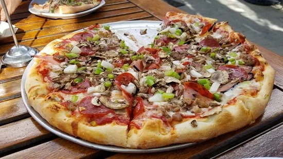 Deluxe (the traditional) - traditional pizza sauce base with mozzarella, pepperoni, sausage, ham, green peppers, onion, and mushroom