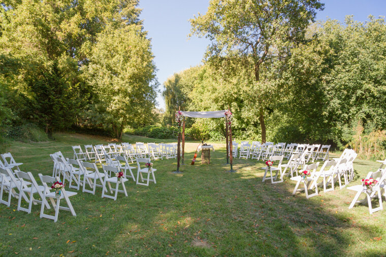 chairs arranged for outside wedding on grass
