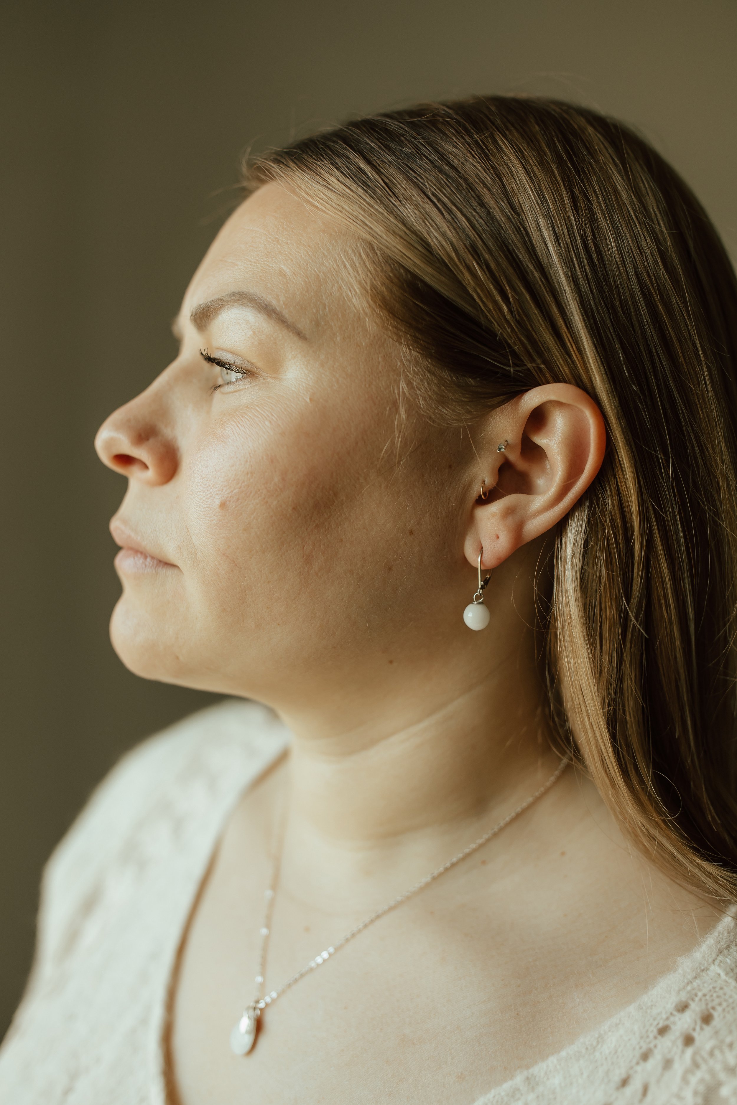 Woman wearing sterling silver Pearl Drop Earrings with lever backs
