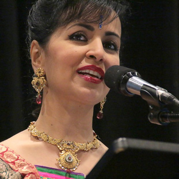 Headshot of Gayathri Ramprasad speaking at a lectern